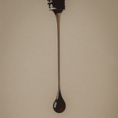 Cosmeceutical skincare range close up of  skincare product dripping from the bottle on beige background