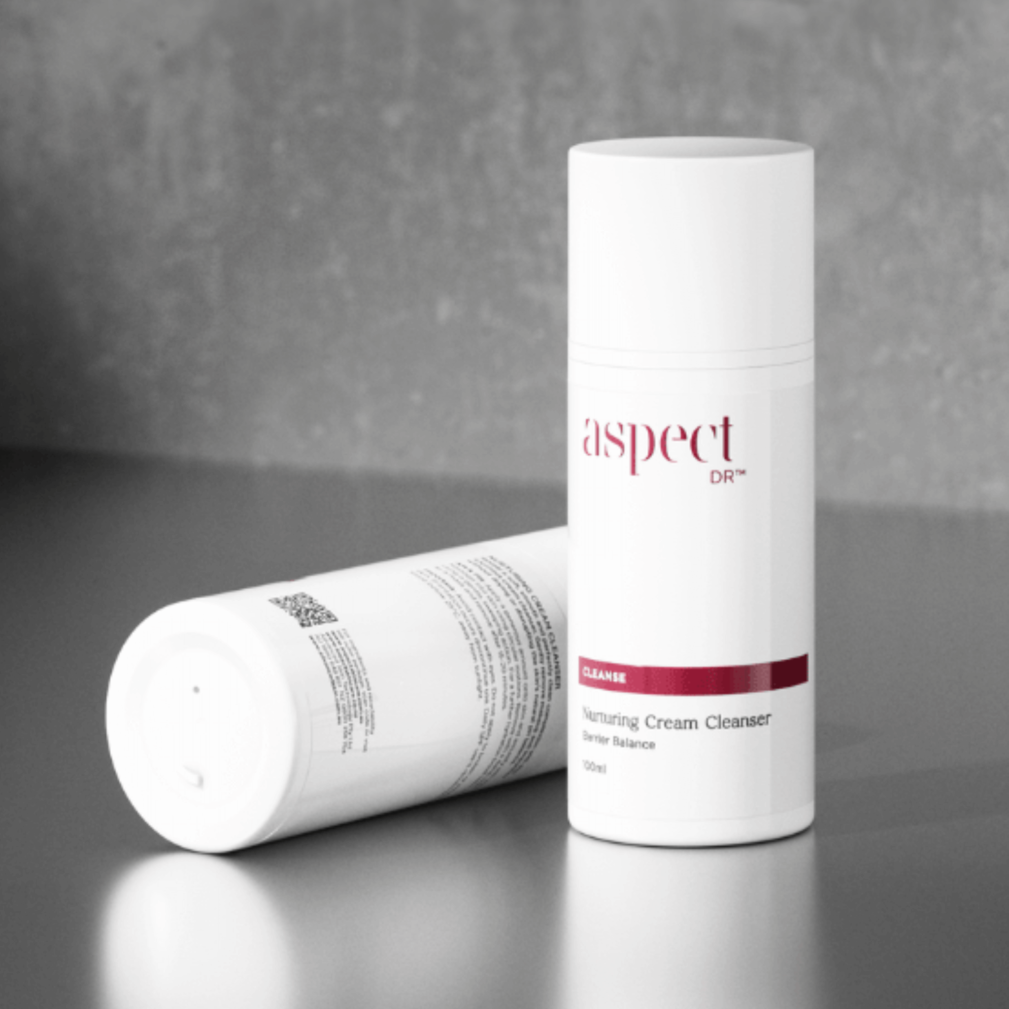Two nurturing cream cleansers branded Aspect Dr on grey background