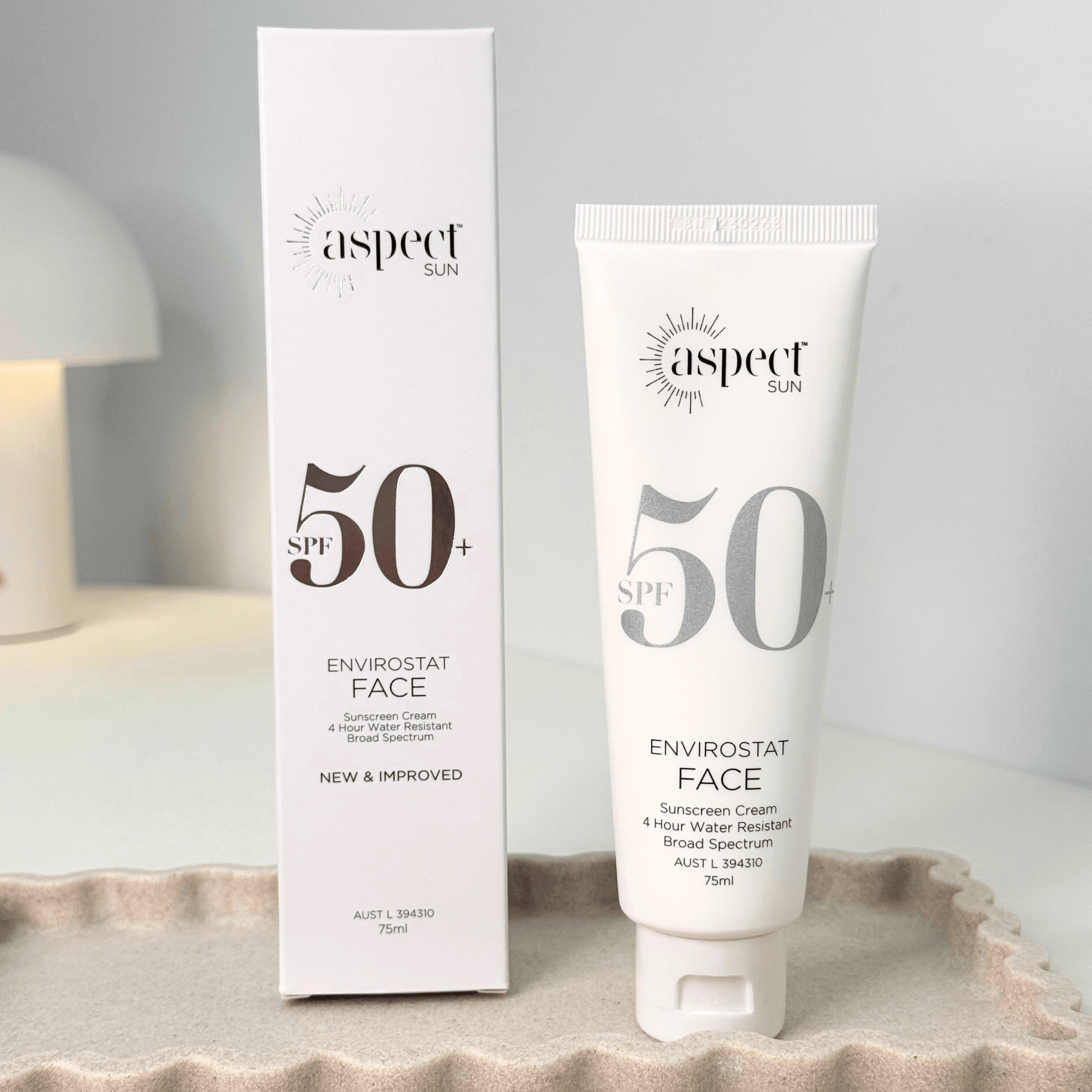 Aspect Sun SPF 50+ Envirostat Face sunscreen cream and packaging on a neutral background