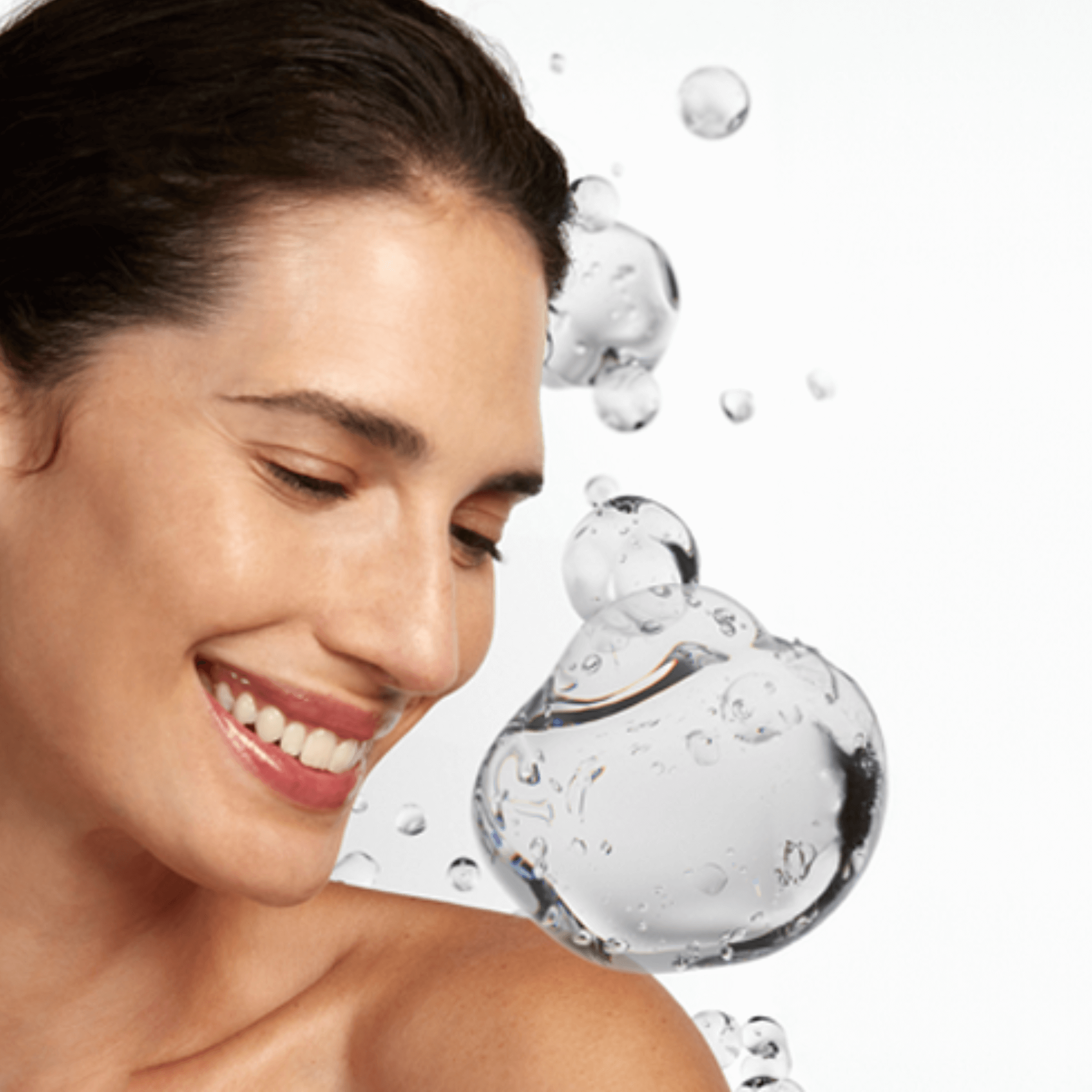 Woman with a smile next to a glass bottle with water droplets ISBA Skincare
