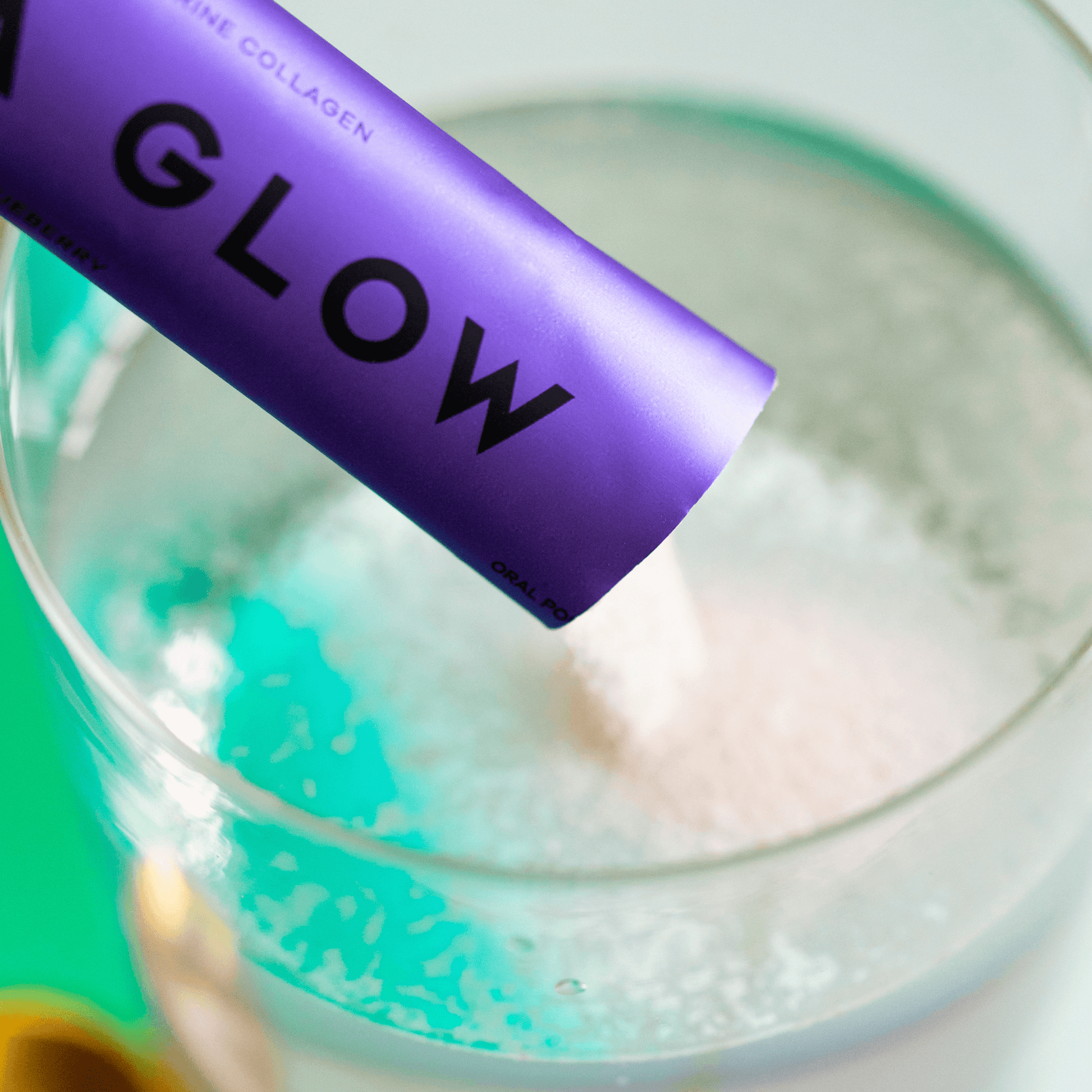 Vida Glow blueberry sachet powder poured in glass