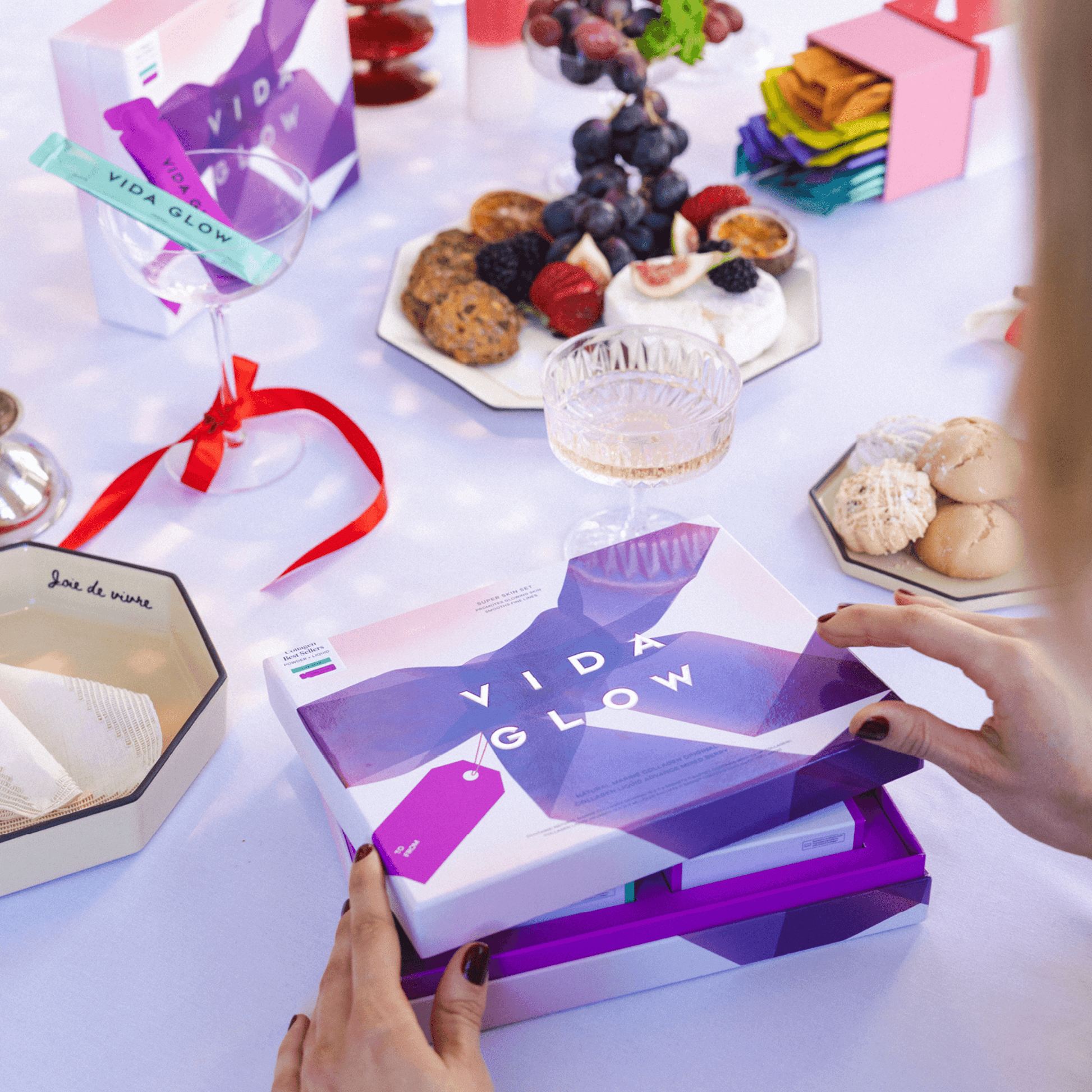 Vida Glow collagen limited edition packs on festive table with food and drinks