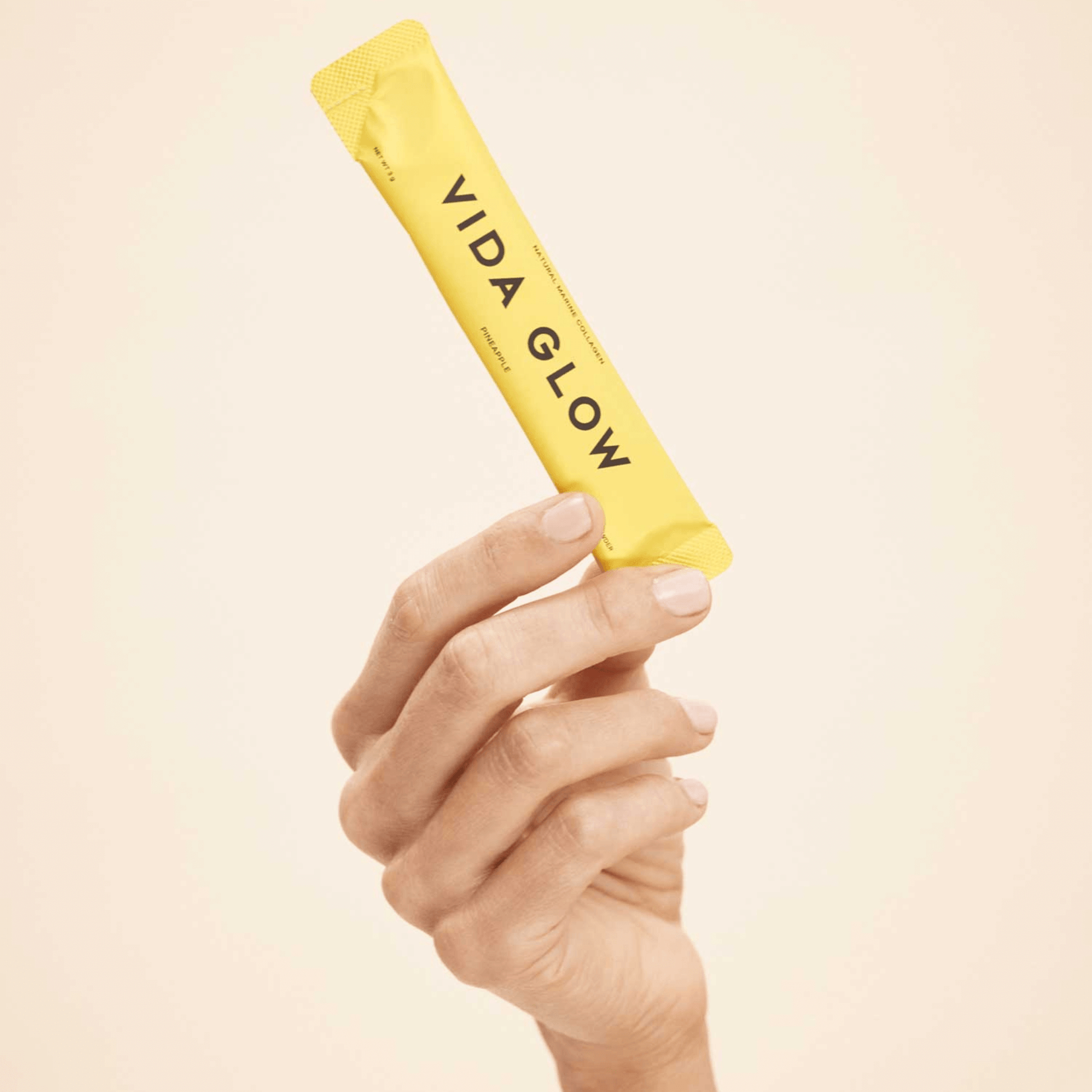 Vida Glow Pineapple flavour sachet close up handheld