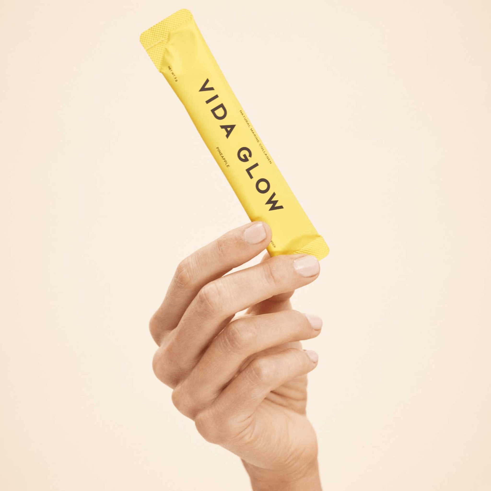 Vida Glow Pineapple flavour sachet close up handheld