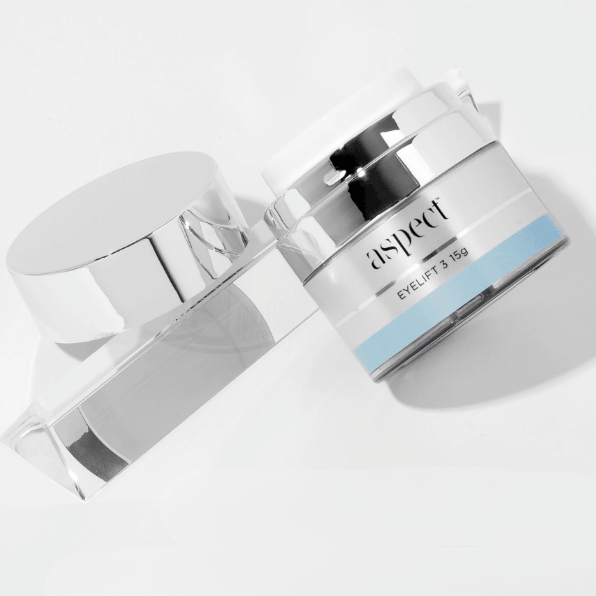 Lid and jar of Aspect eyelift on a light grey background