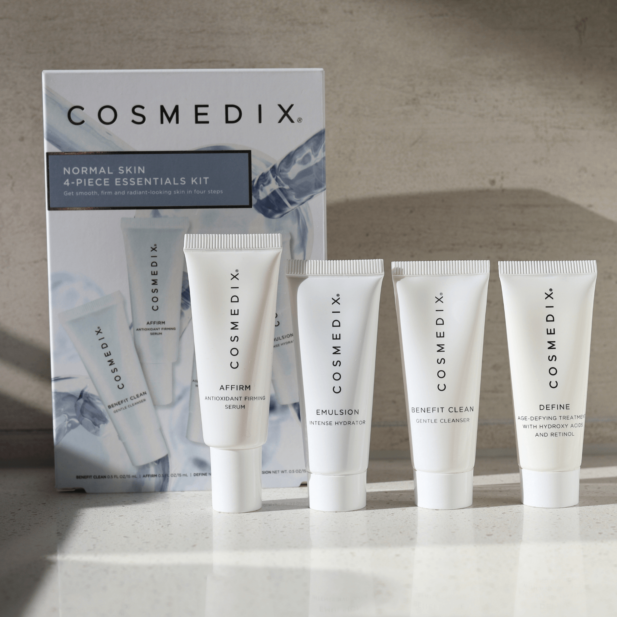 Cosmedix skincare products set 'Normal Skin 4-piece essentials kit' with packaging on a neutral background