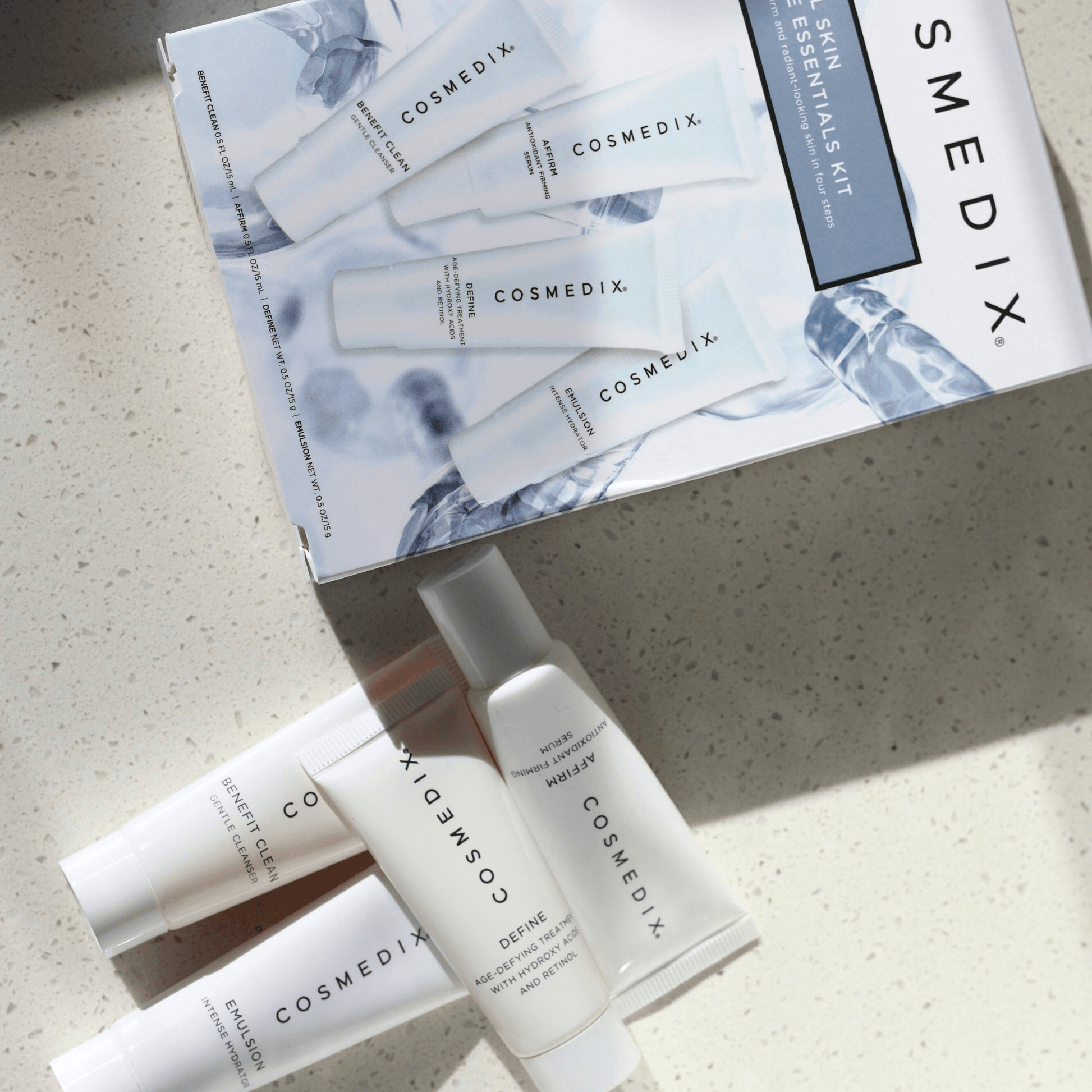 Cosmedix skincare products from 4 Piece essentials kit and packaging on a light surface