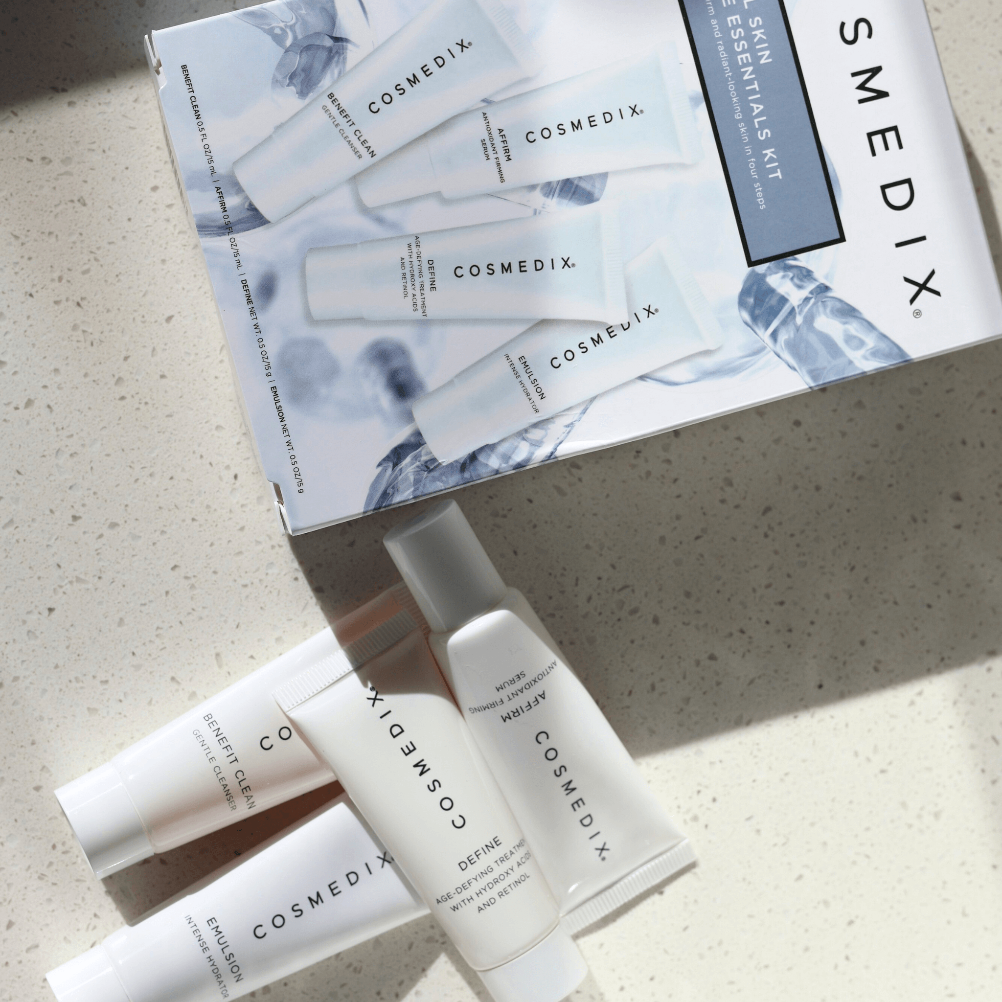 Cosmedix skincare products from 4 Piece essentials kit and packaging on a light surface
