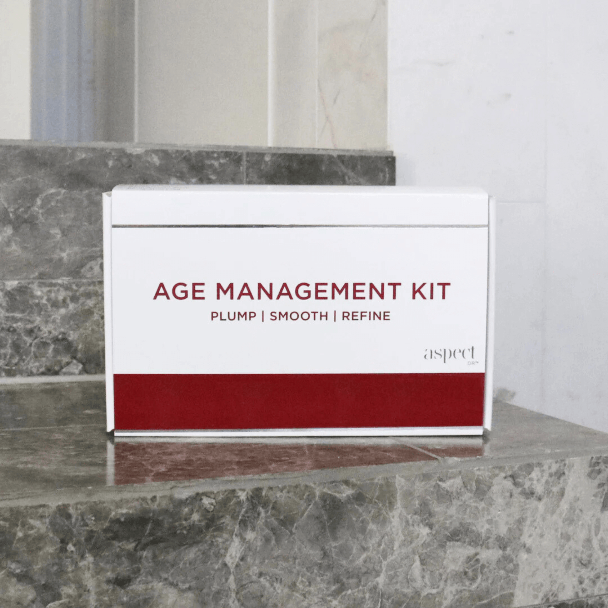 Age Management Kit - Plump, smooth, refine on grey marble bathroom counter with mirror