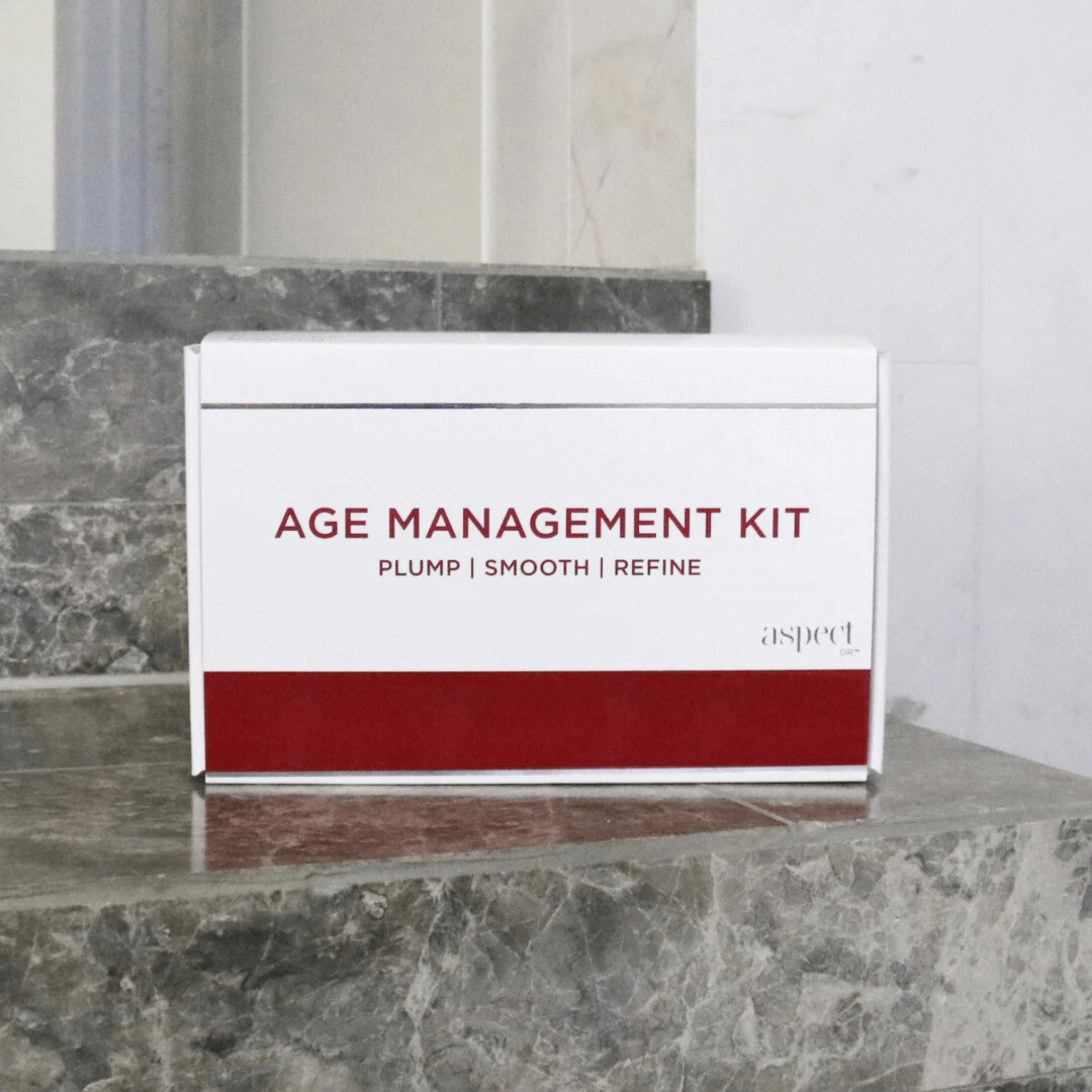 Age Management Kit - Plump, smooth, refine on grey marble bathroom counter with mirror