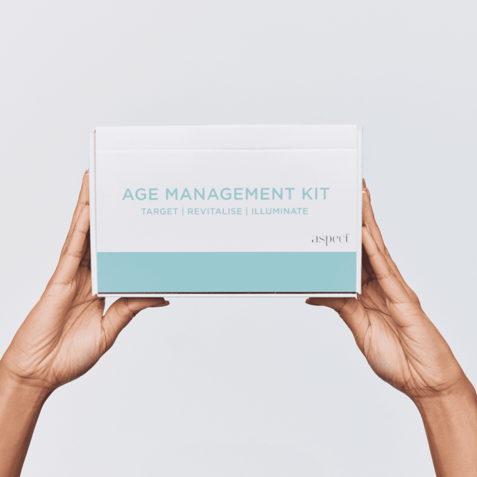 Aspect Age management kit box held by hands against a light grey background