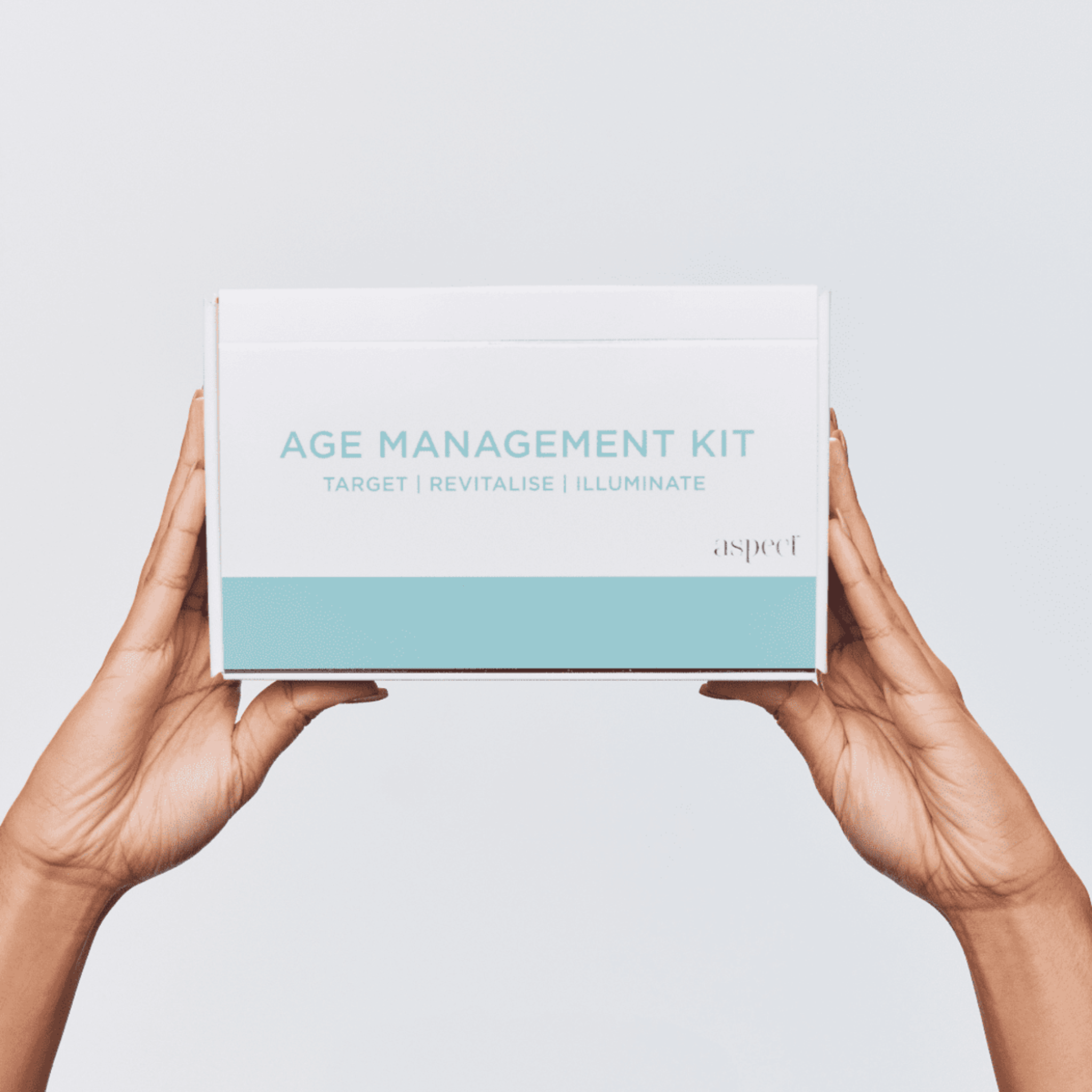 Aspect Age management kit box held by hands against a light grey background