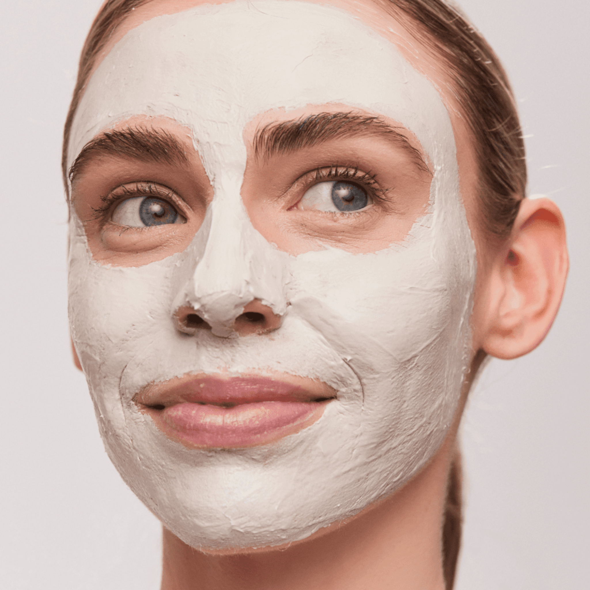 Woman wearing Aspect Exfoliating Clay Mask on a plain background