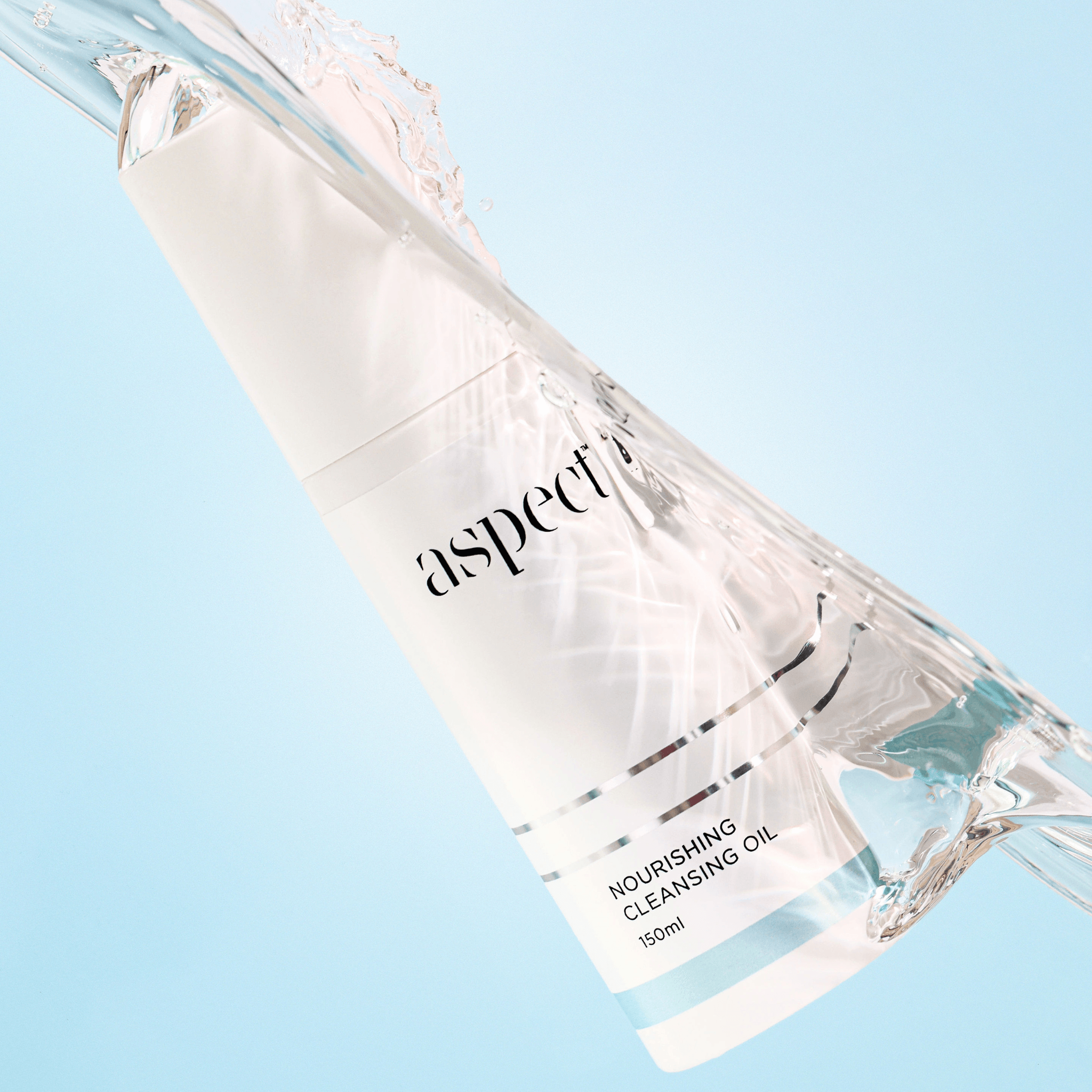 Bottle of 'aspect' nourishing cleansing oil on a light blue background