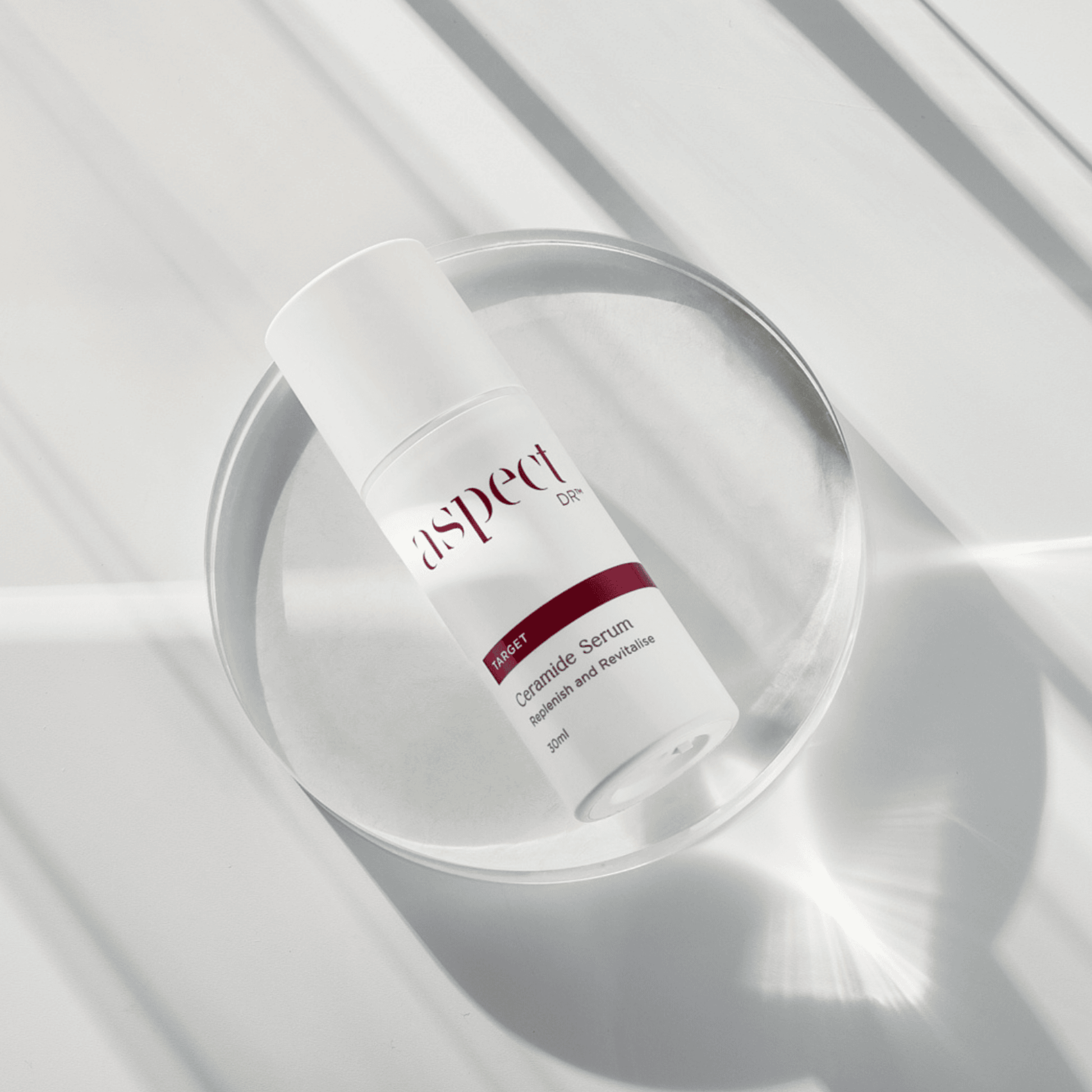 Aspect Dr Ceramide Serum replenish and revitalise laying on glass dish on white background