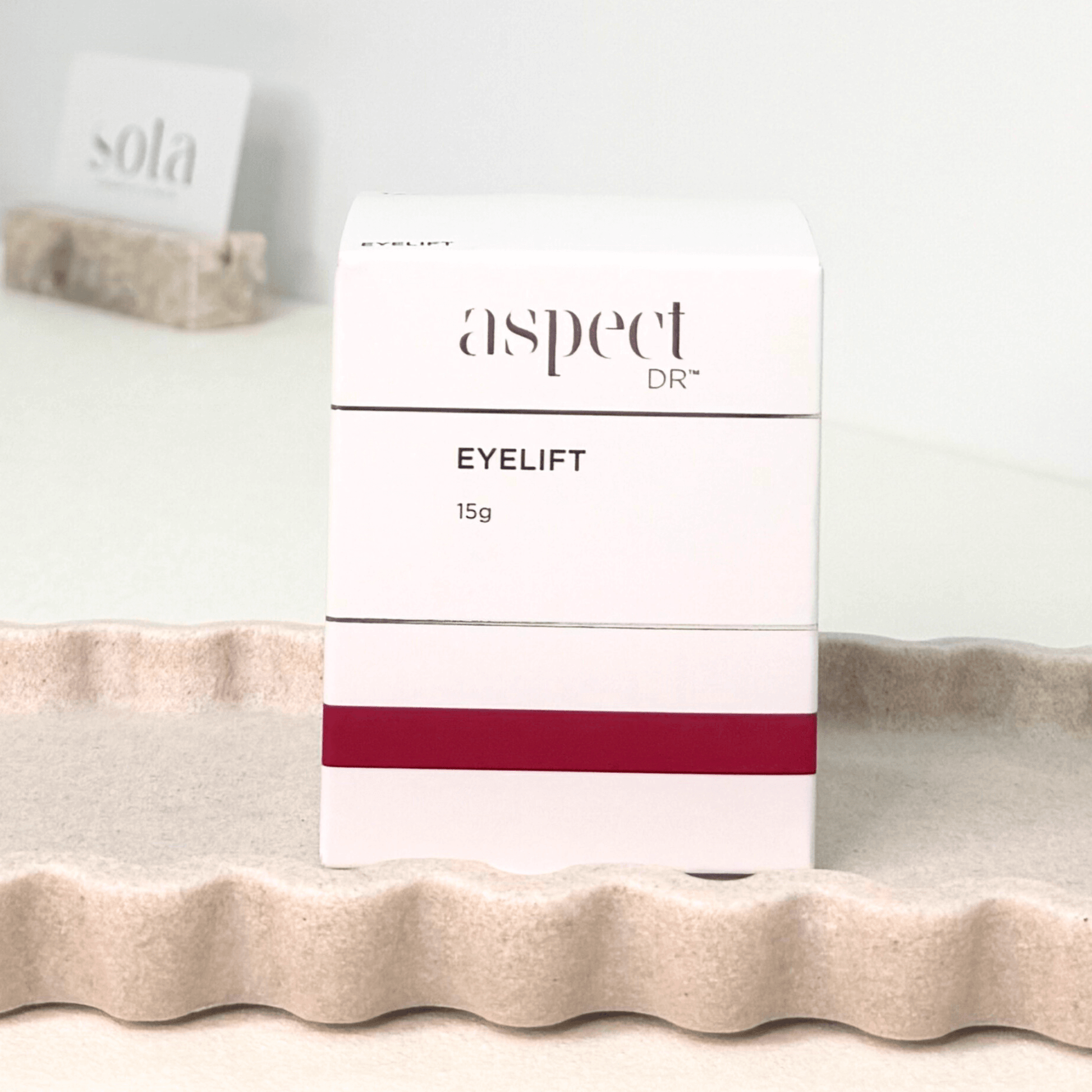 Aspect Dr eyelift cream on a textured surface on neutral background