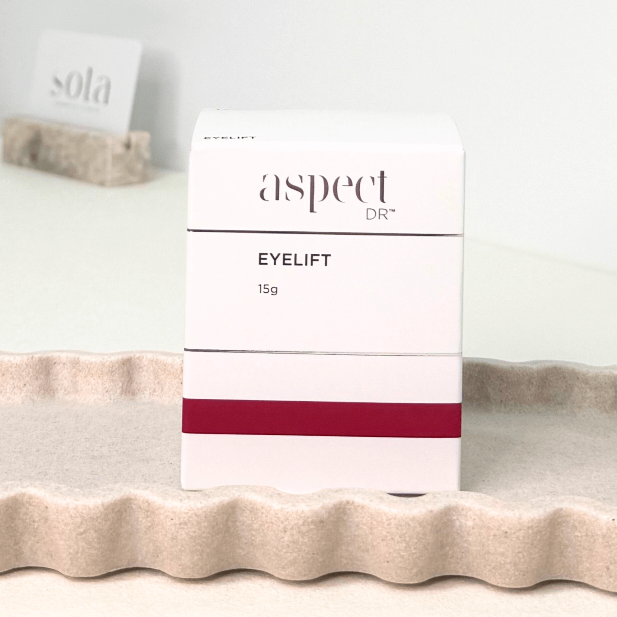 Aspect Dr eyelift cream on a textured surface on neutral background