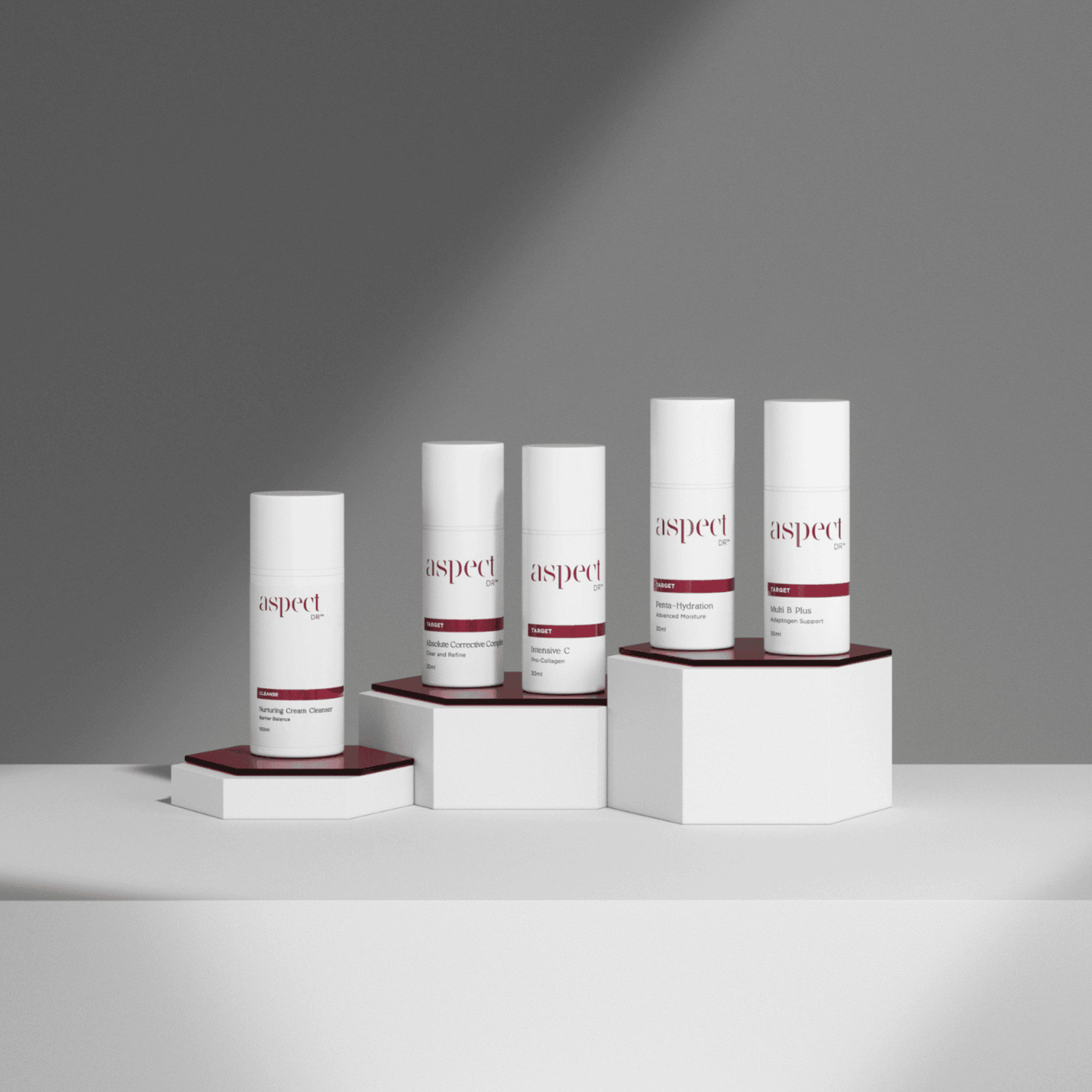 Set of skincare products labeled 'aspect dr' on a grey background