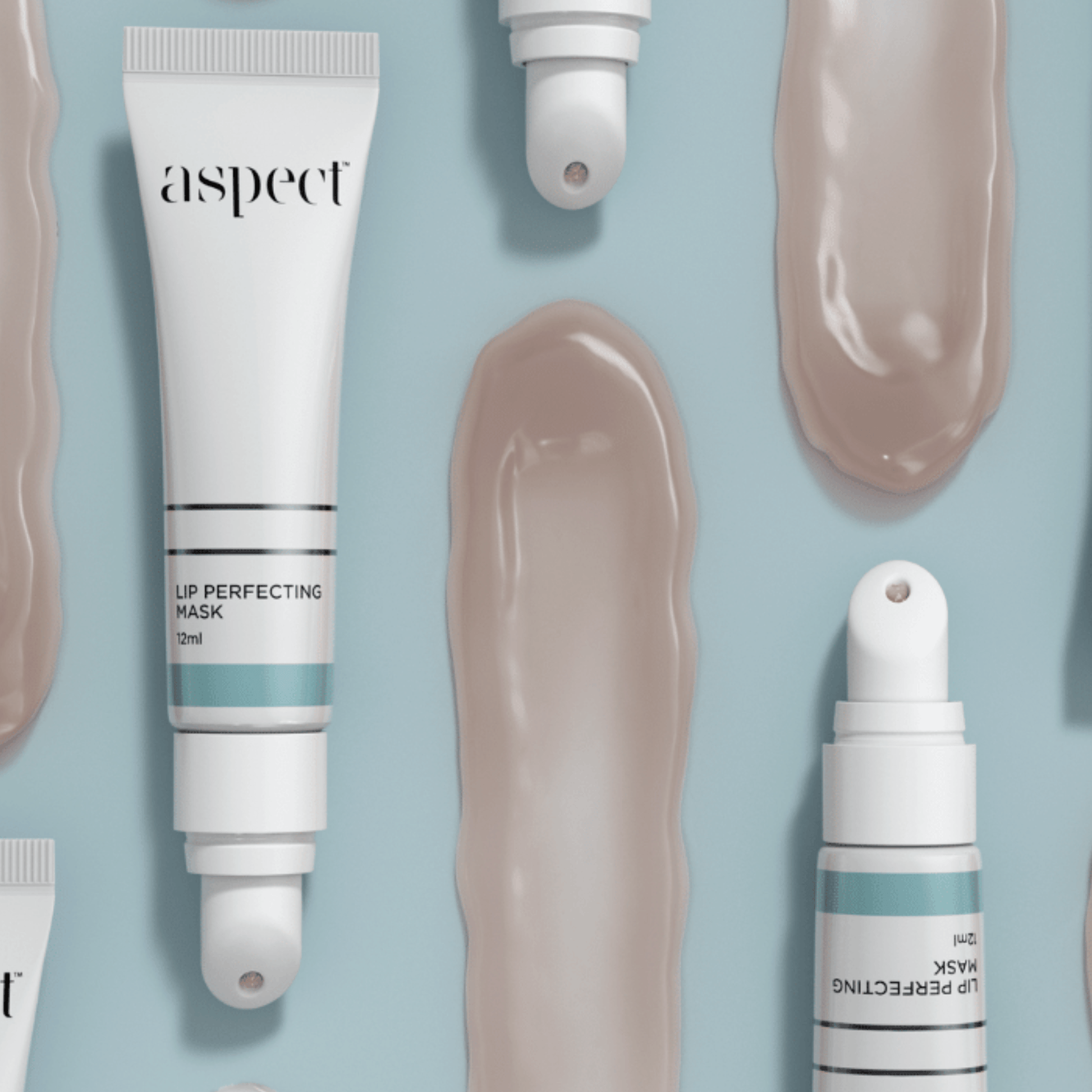 Aspect Lip Perfecting Mask tubes and dropper on a light blue background
