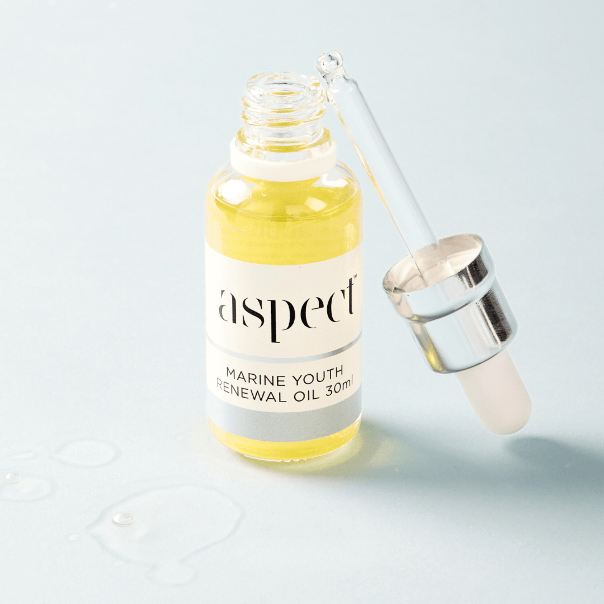 Marine youth renewal oil bottle with dropper on a light grey background