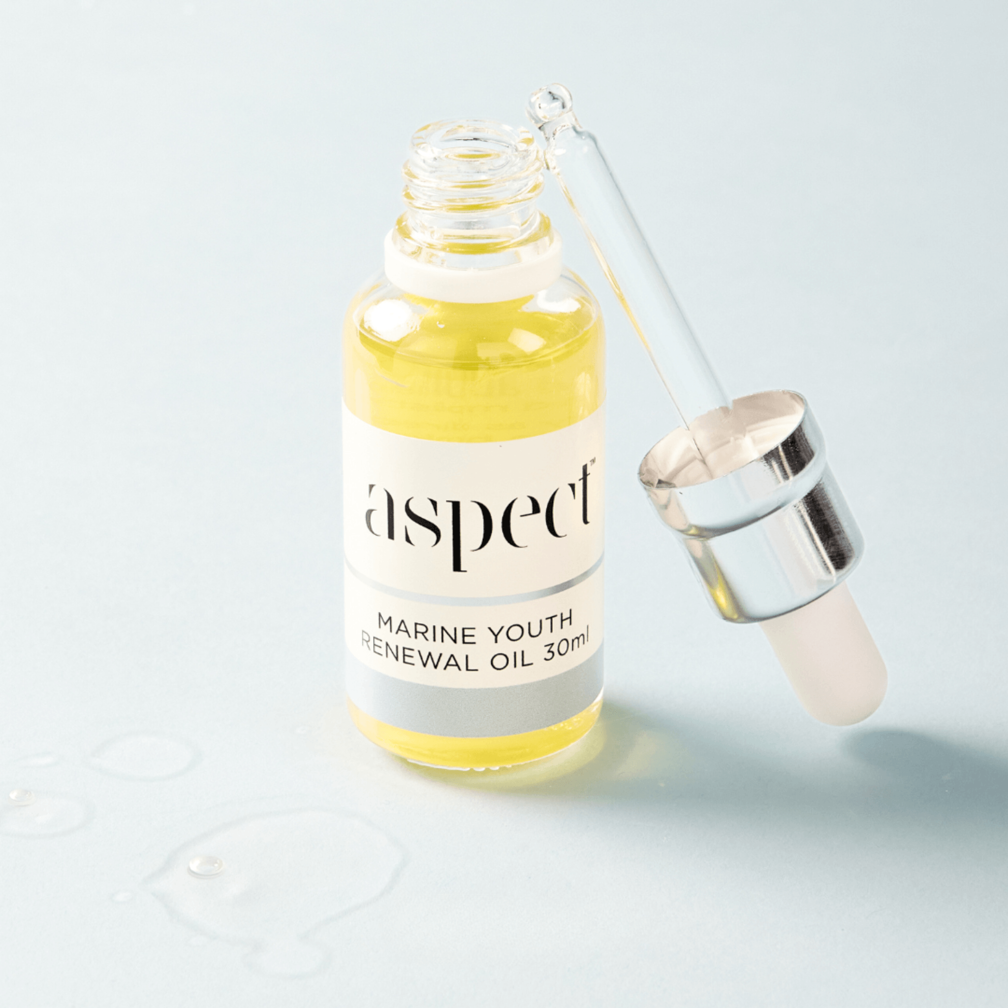 Marine youth renewal oil bottle with dropper on a light grey background