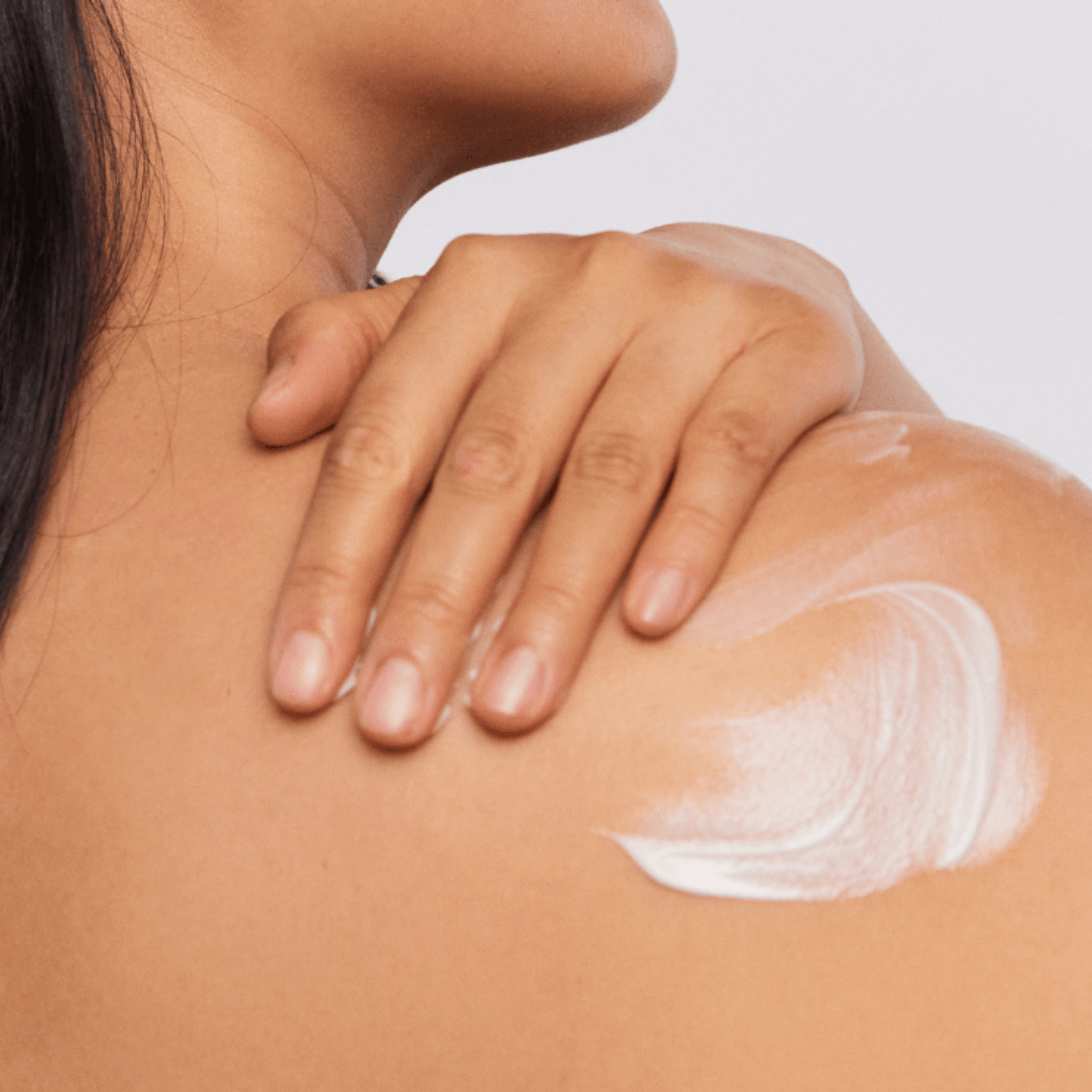Aspect Pigment Punch Body applying white cream to shoulder with hand
