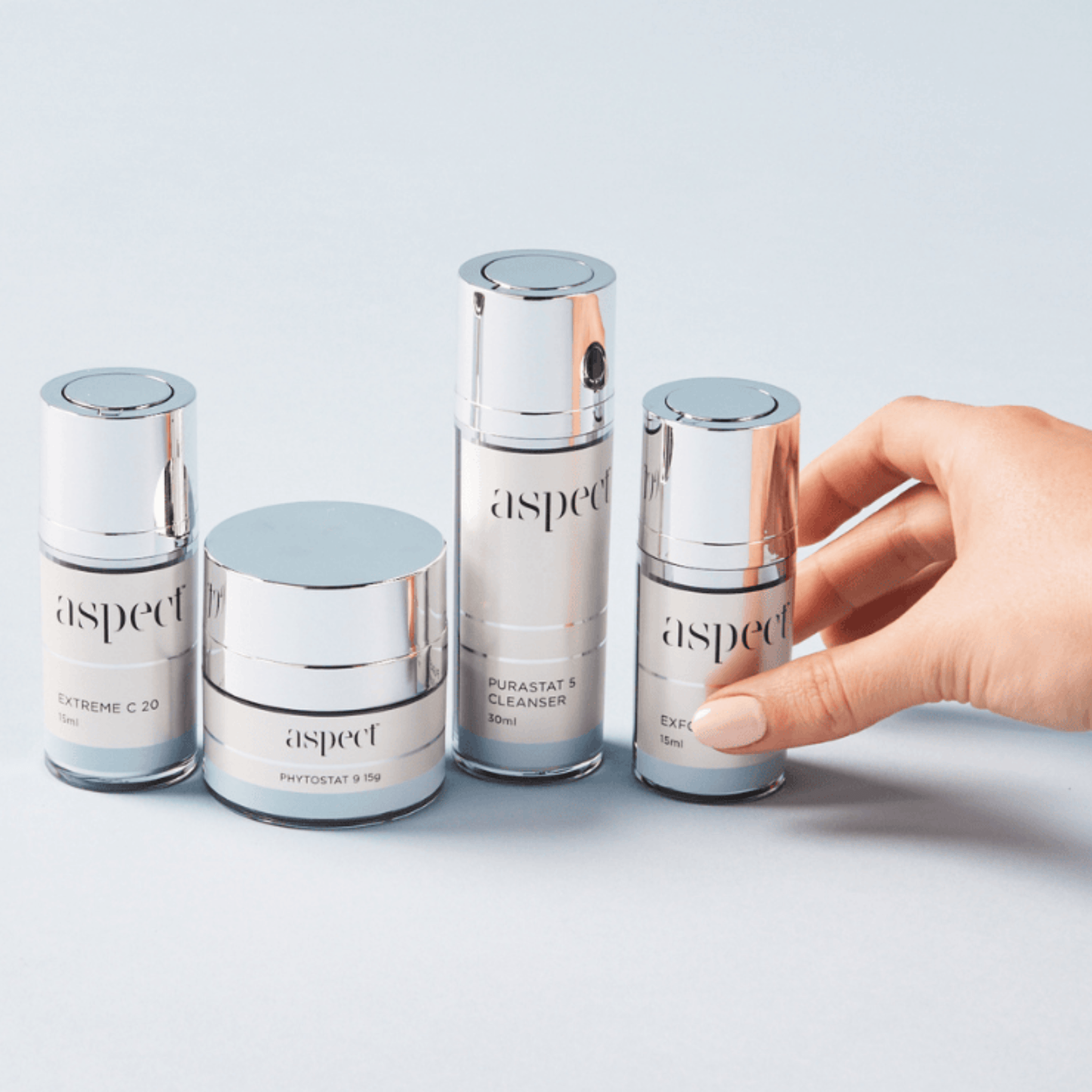 Set of Aspect skincare products from the Aspect Starter Kit on a light grey background