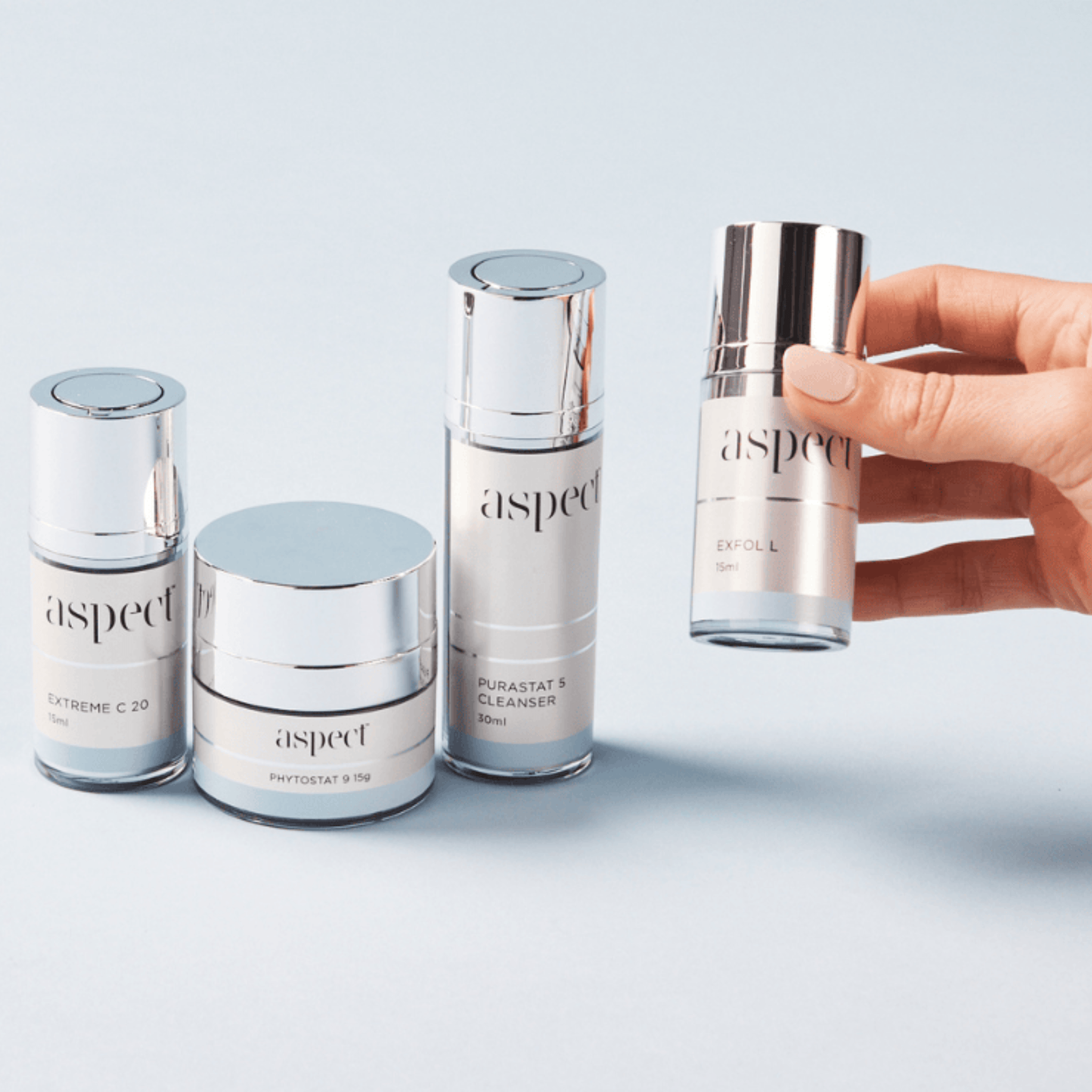 Collection of Aspect skincare products from the Aspect Starter Kit on a light grey background