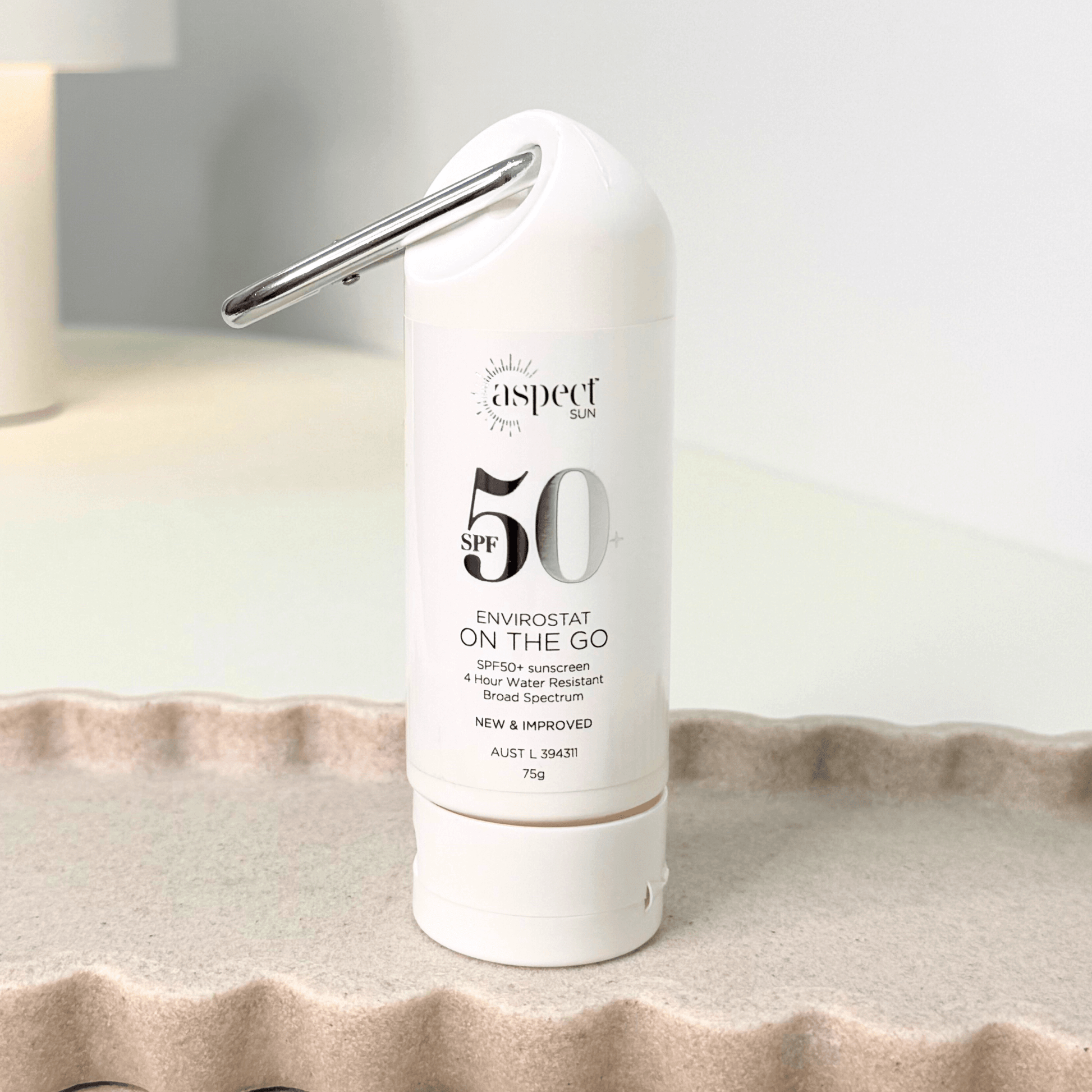 Aspect Sun on the go SPF50 on scalloped tray on neutral background