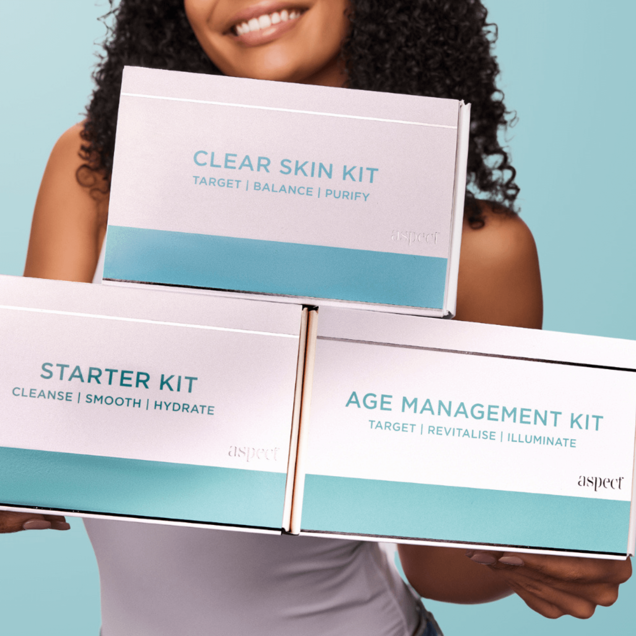 Person holding skincare kit boxes with 'aspect' branding on a light blue background