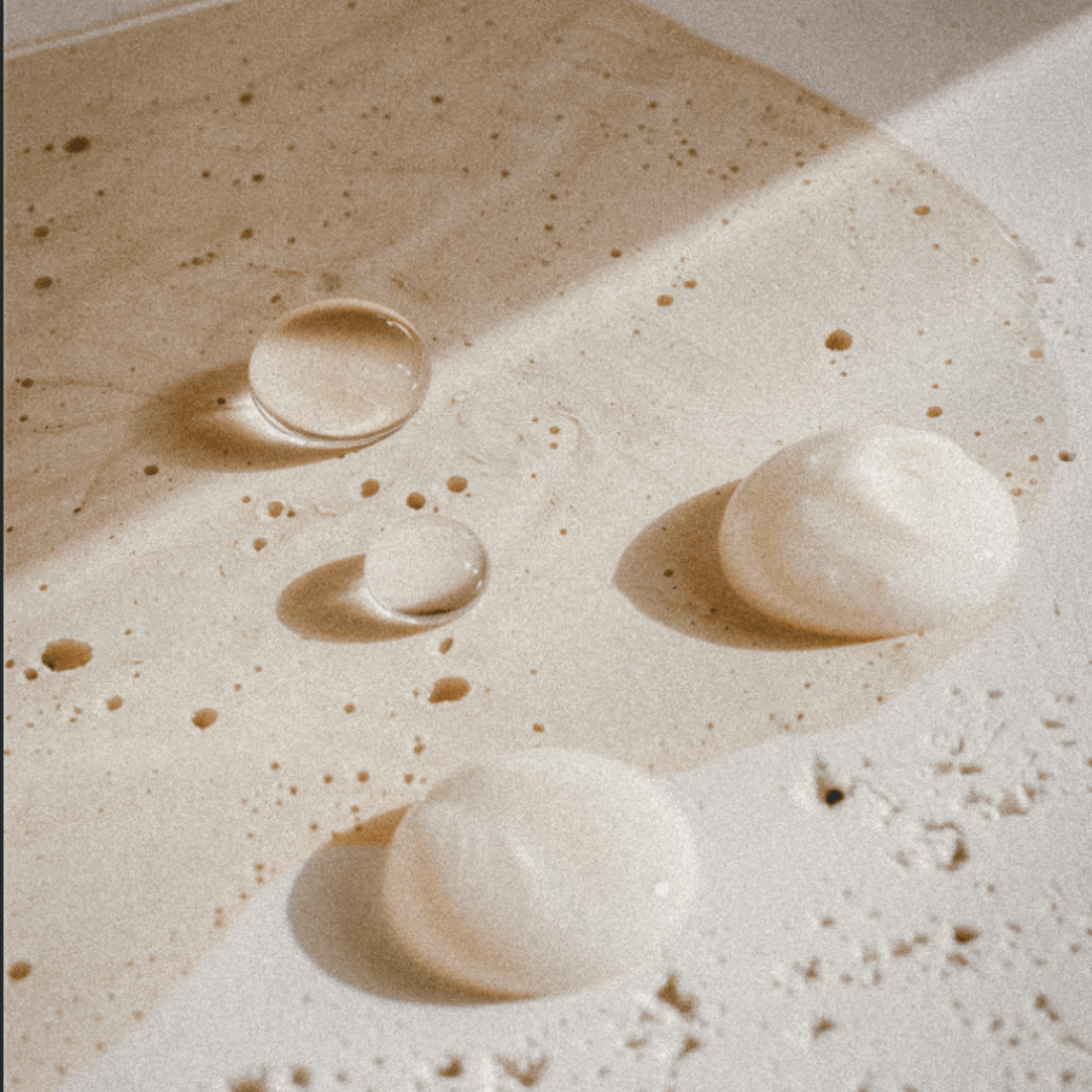 Australian Cosmeceutical skin care multiple swatches on neutral stone background