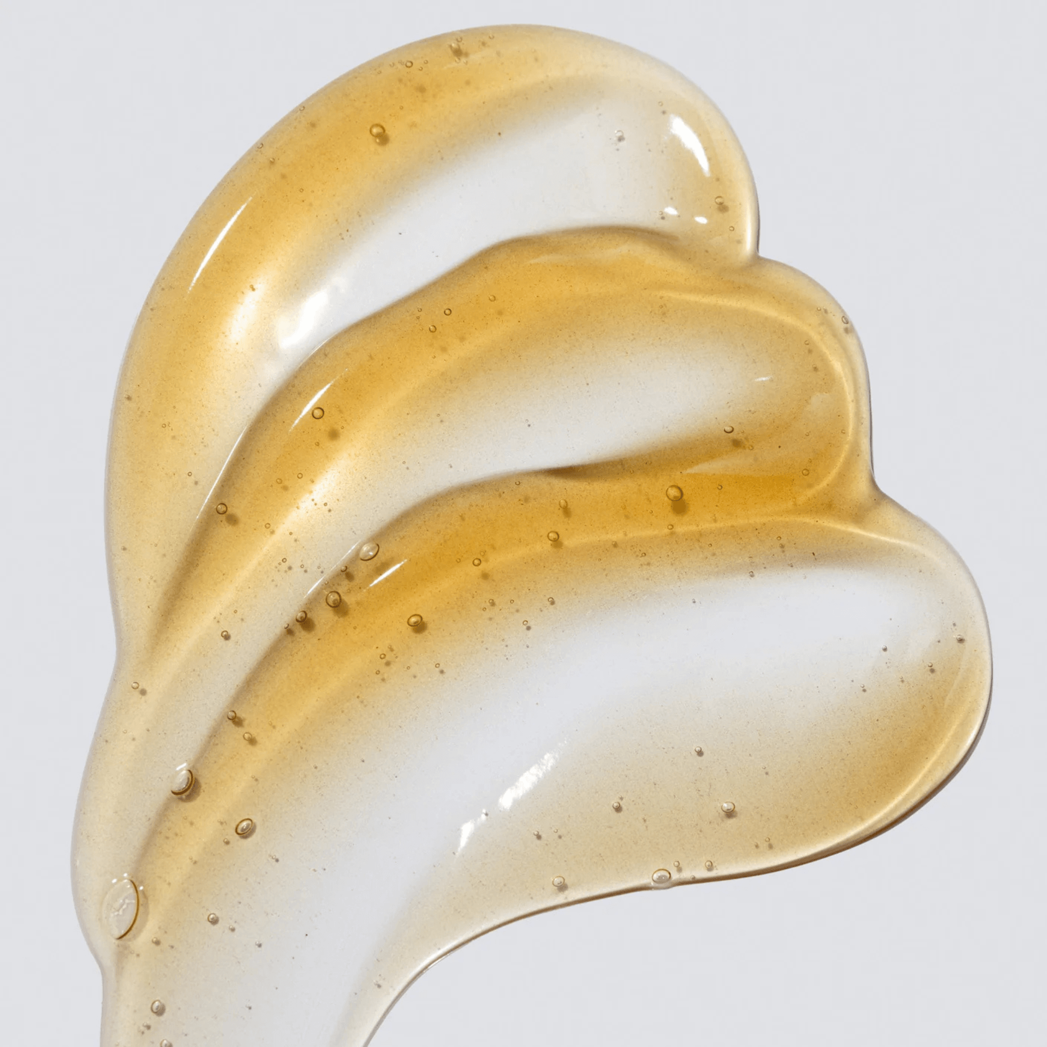 Close-up of a Cosmedix Elite awaken swirl of cream on a light grey background