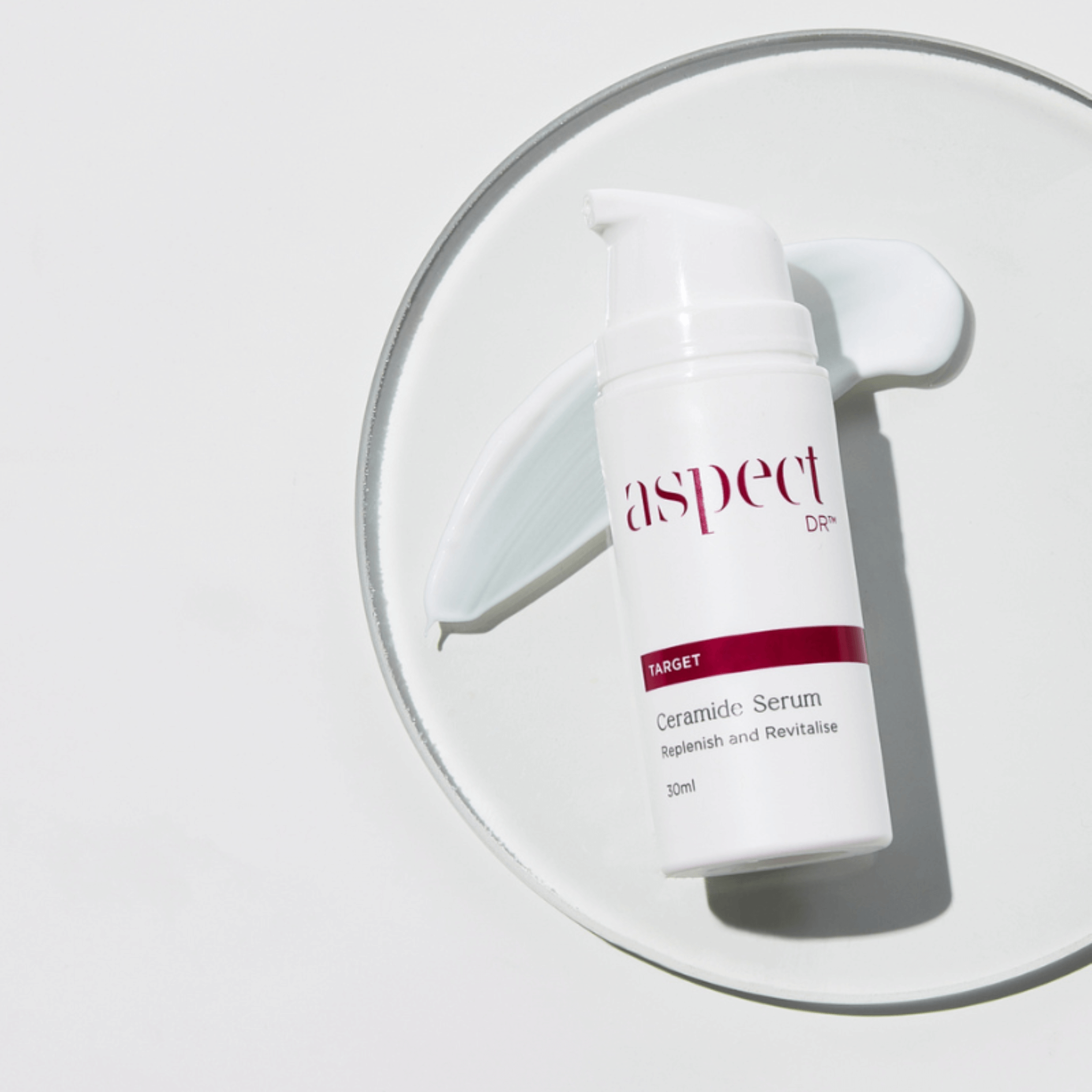 Ceramide Serum Aspect laying on glass dish with product swatch on white background
