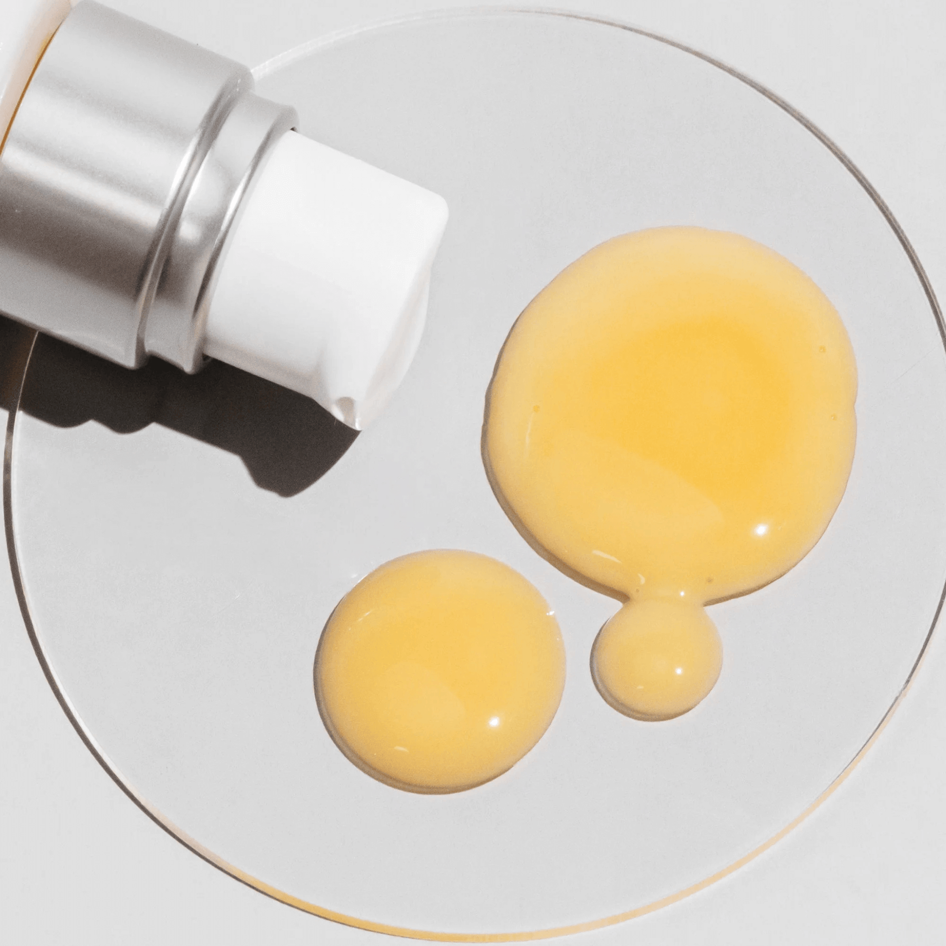 Close-up of cosmedix Clarity serum cream being squeezed onto a white surface