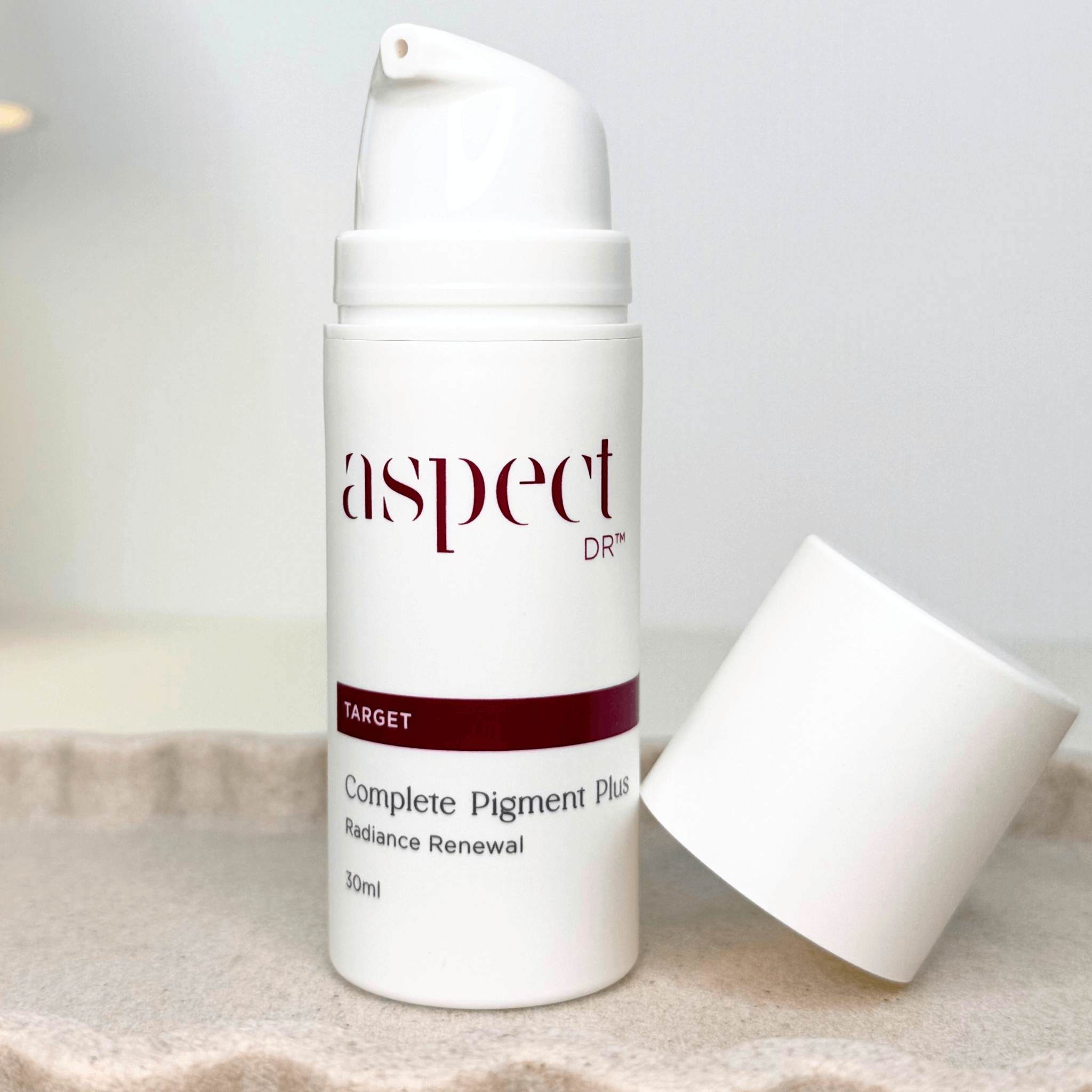 Complete Pigment Plus Radiance Renewal with lid leaning on product on neutral background