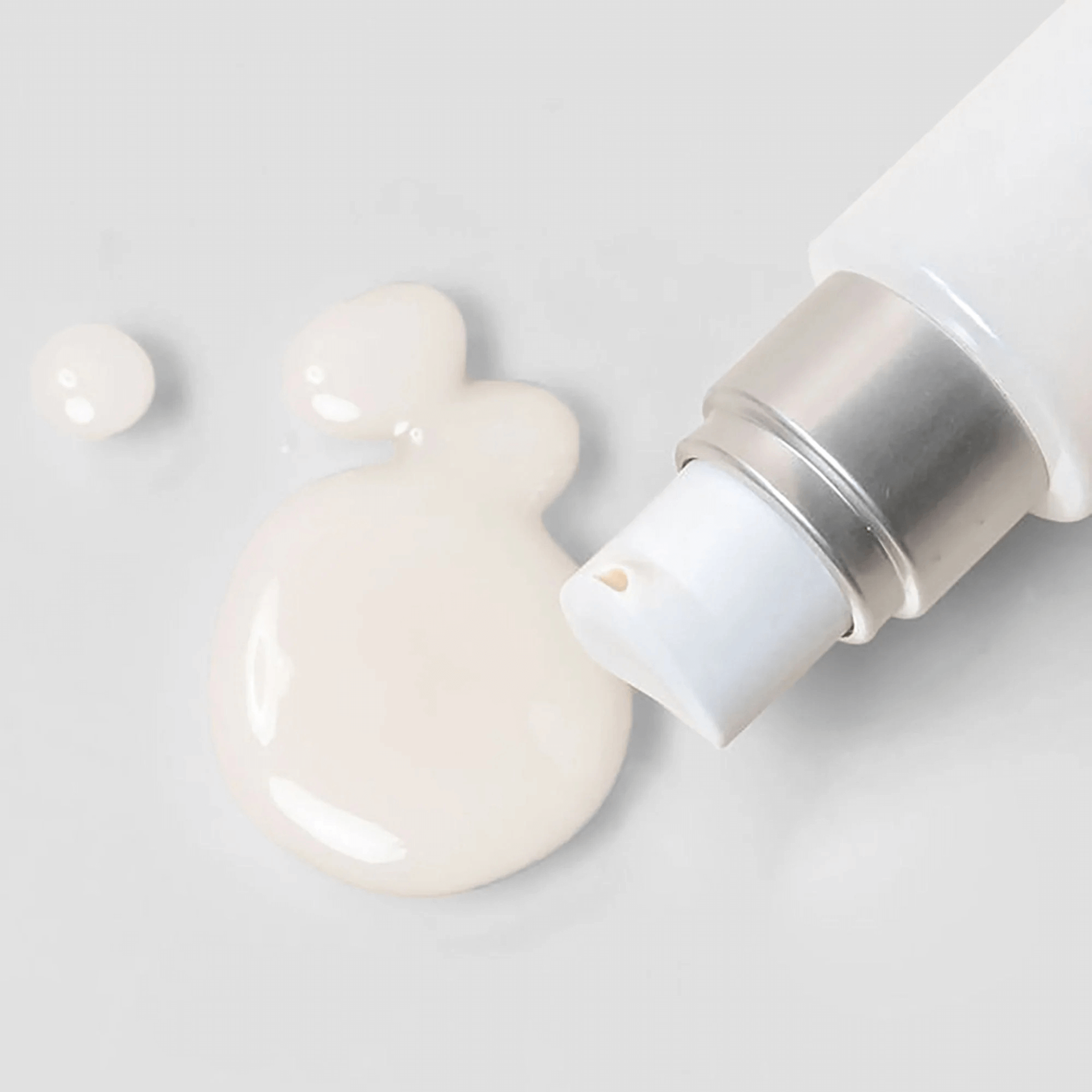 Cosmedix Affirm product being dispensed from a pump onto a white surface