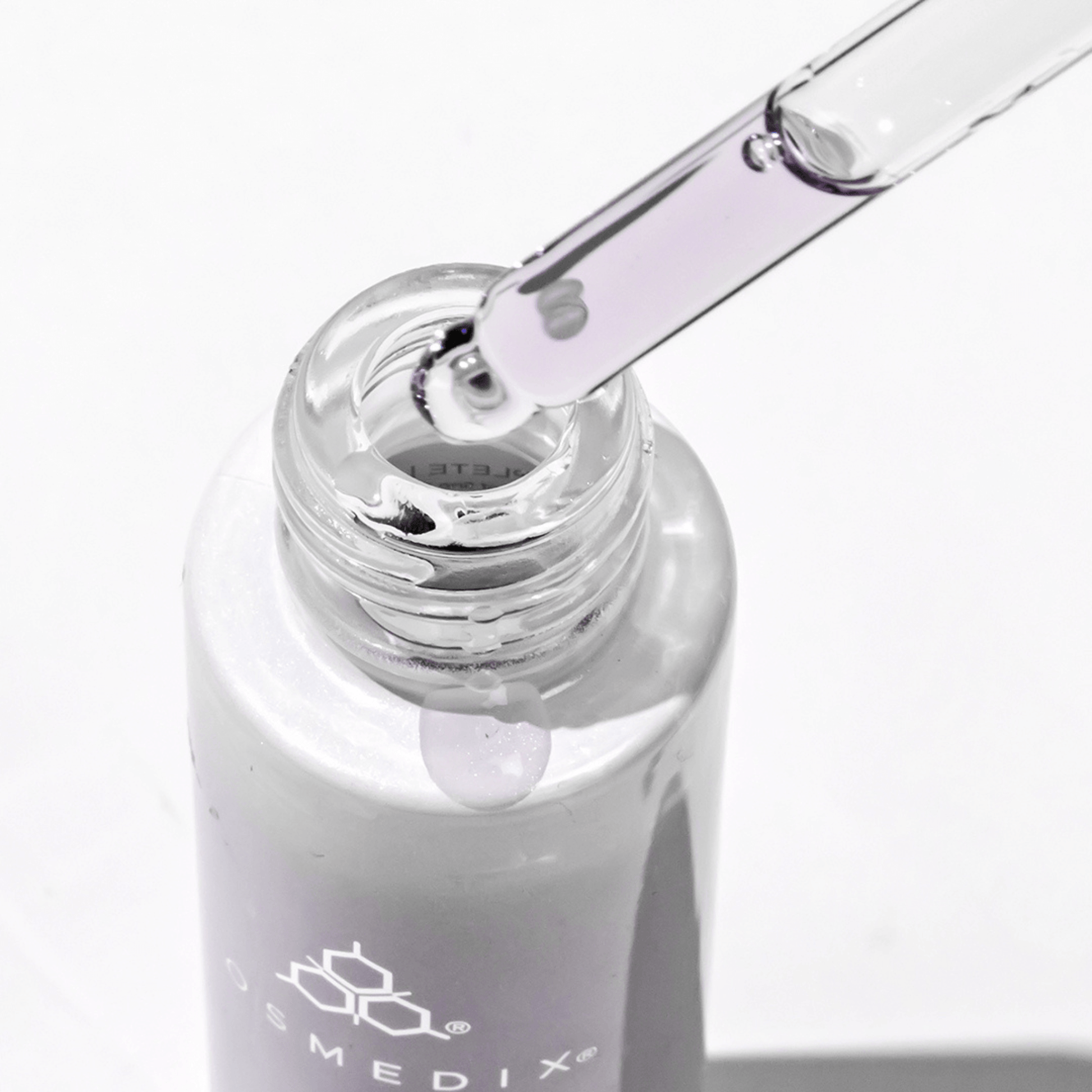 Cosmedix Bakuchiol skincare bottle with dropper on a white background with purple liquid in dropper