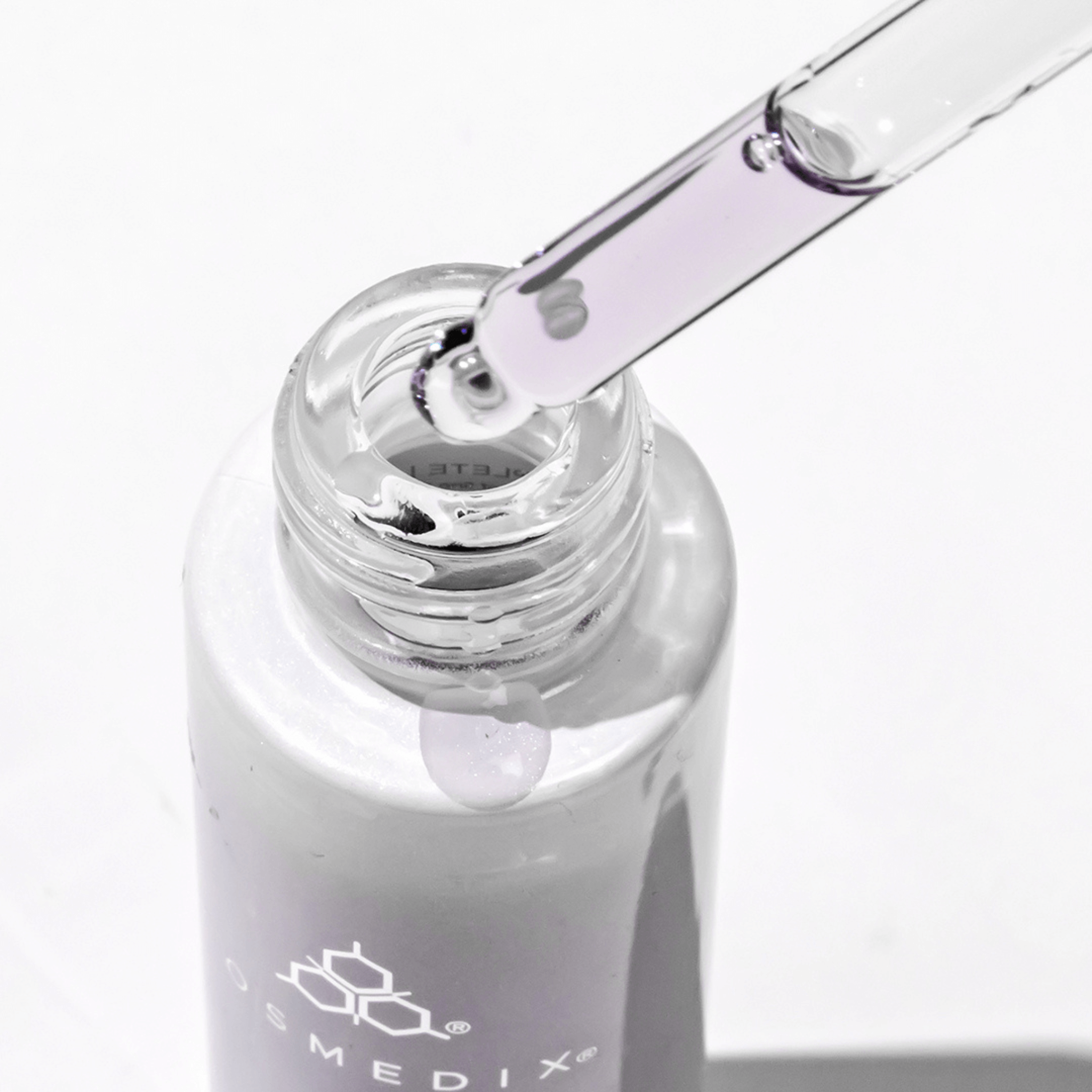 Cosmedix Bakuchiol skincare bottle with dropper on a white background with purple liquid in dropper