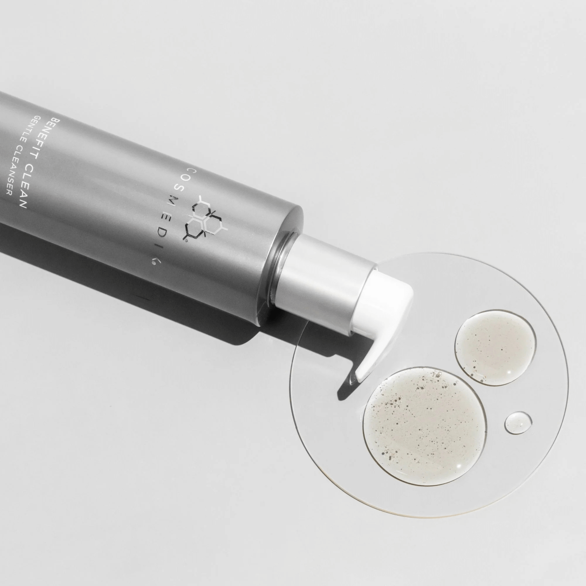 Cosmedix benefit balance bottle with foam on a white background