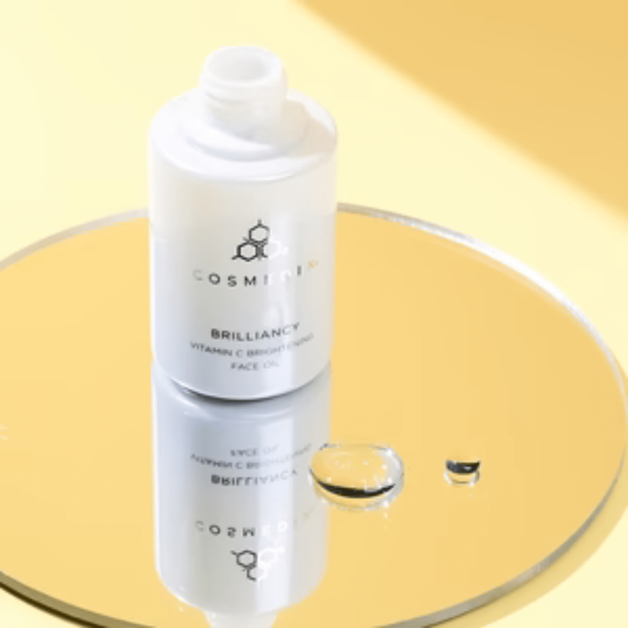 Cosmedix Brilliancy Vitamin C face oil on a yellow background