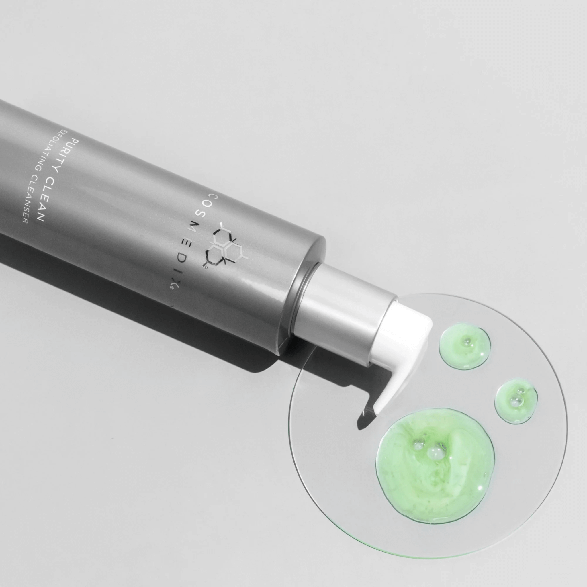 Cosmedix Purity Cleanser with iridescent green cleanser on a light grey background