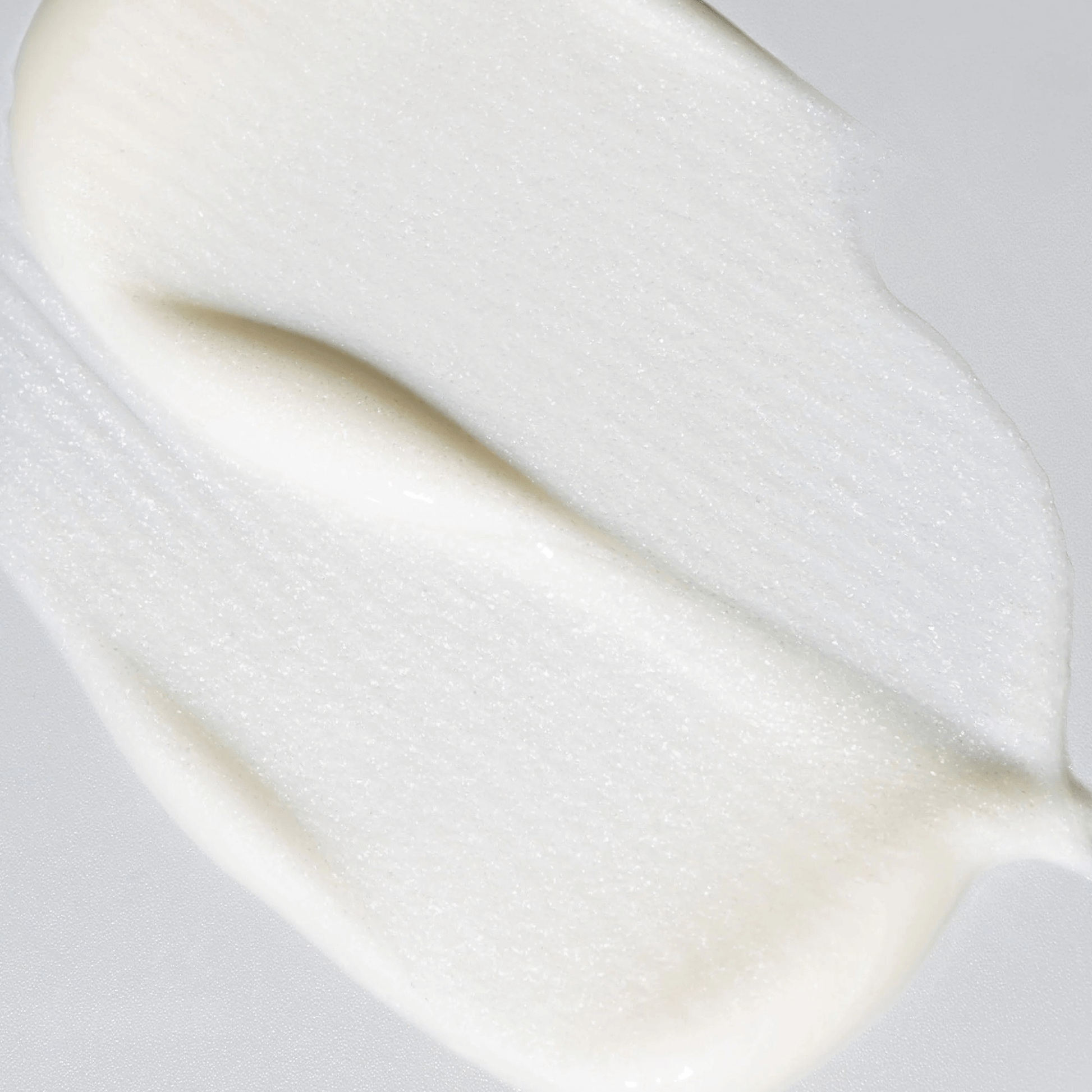 Close up of Cosmedix Crystal Cleanser texture on a light grey background