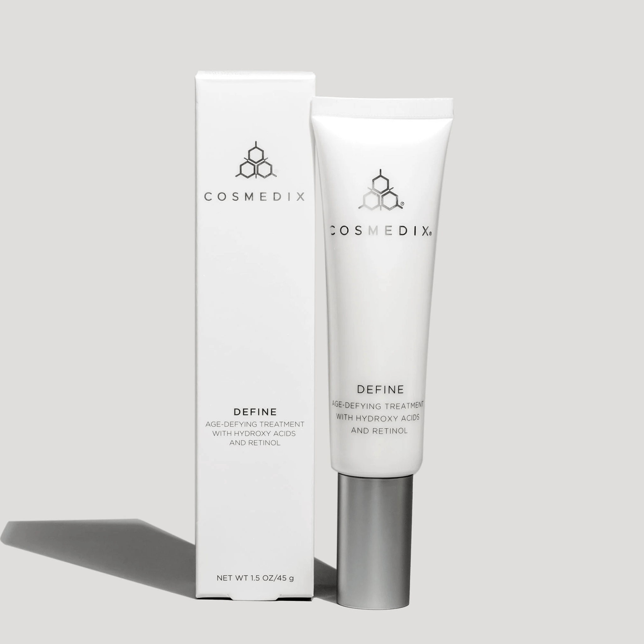 Cosmedix Define skincare treatment with packaging on a grey background