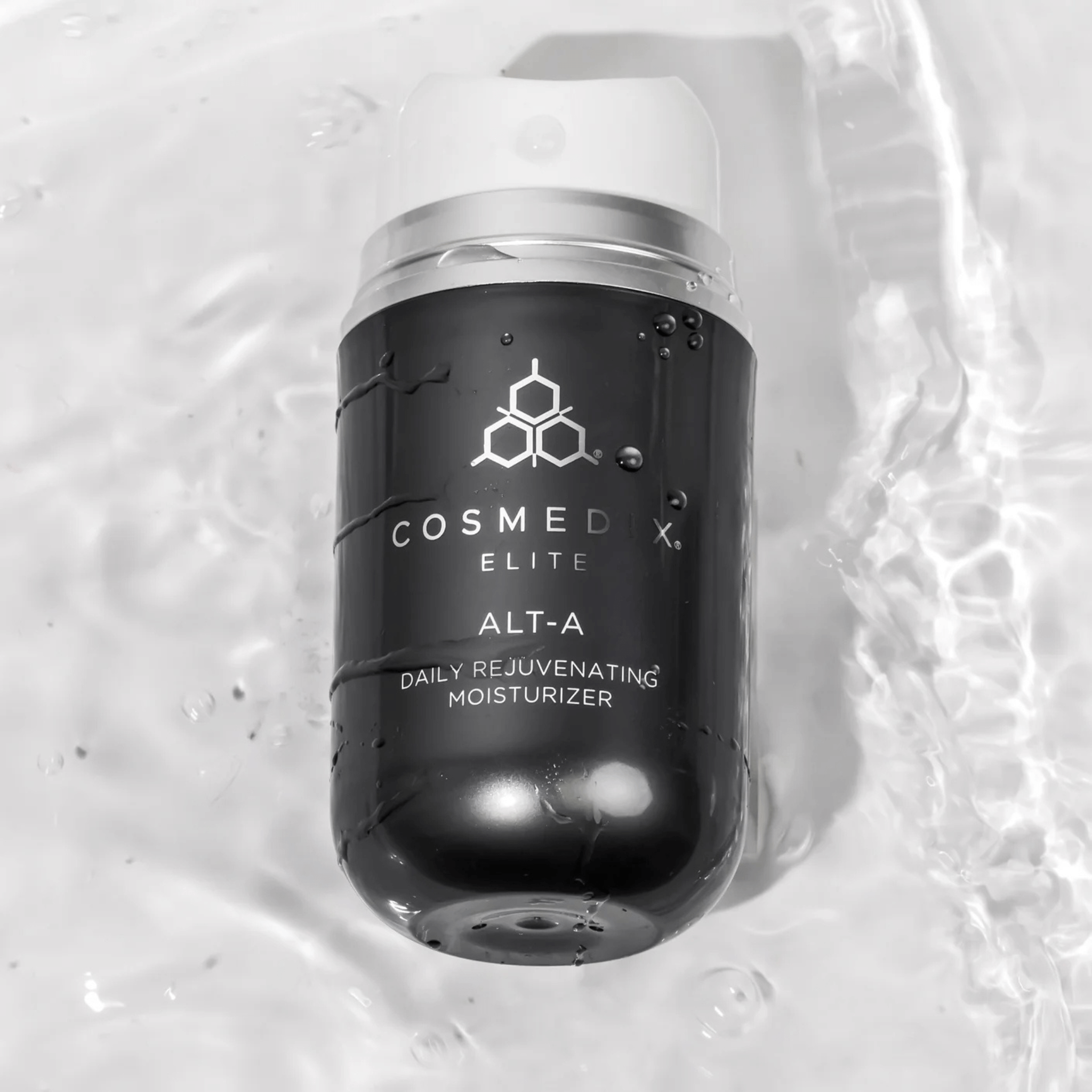Cosmedix Elite ALT-A moisturiser bottle on a textured white background