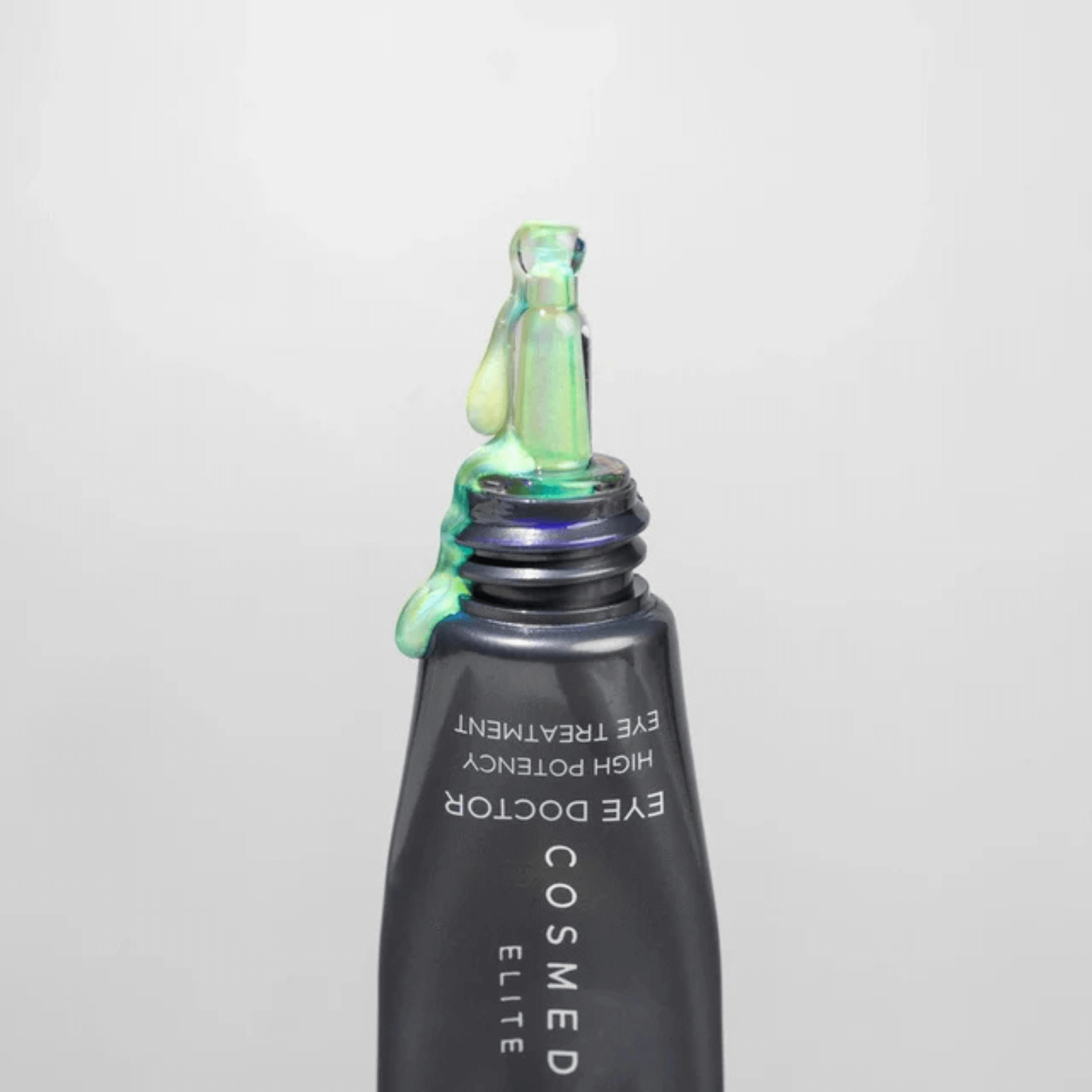 Cosmedix Elite eye treatment bottle with a dropper on a light grey background