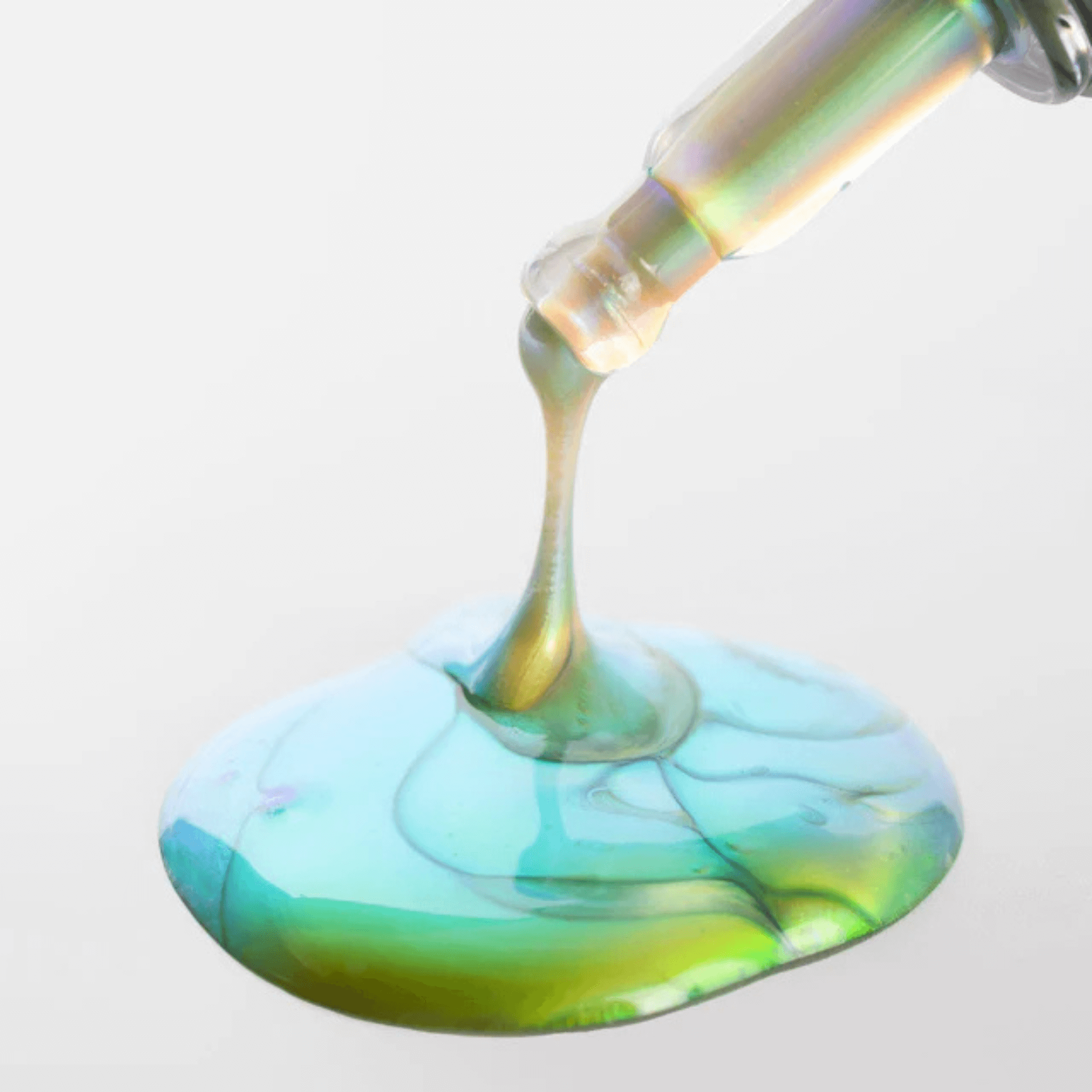 Cosmedix Elite Eye Dr green and blue serum dripping from a tube on a white background