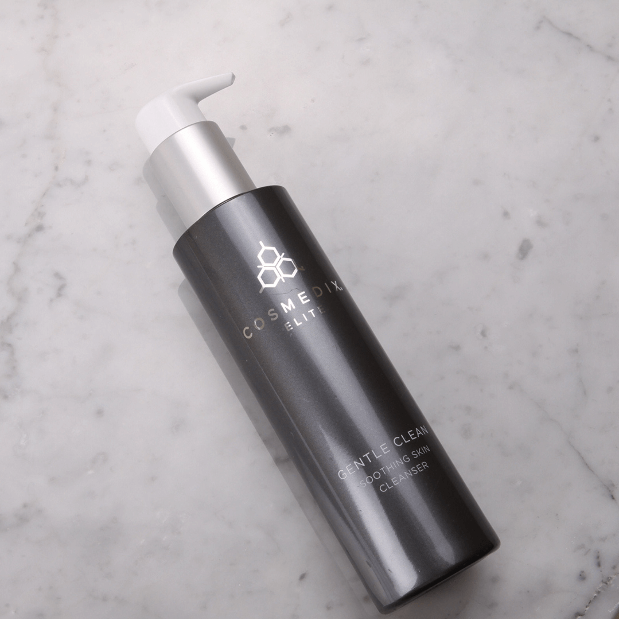 Cosmedix Elite Gentle Cleanser laying on white marble