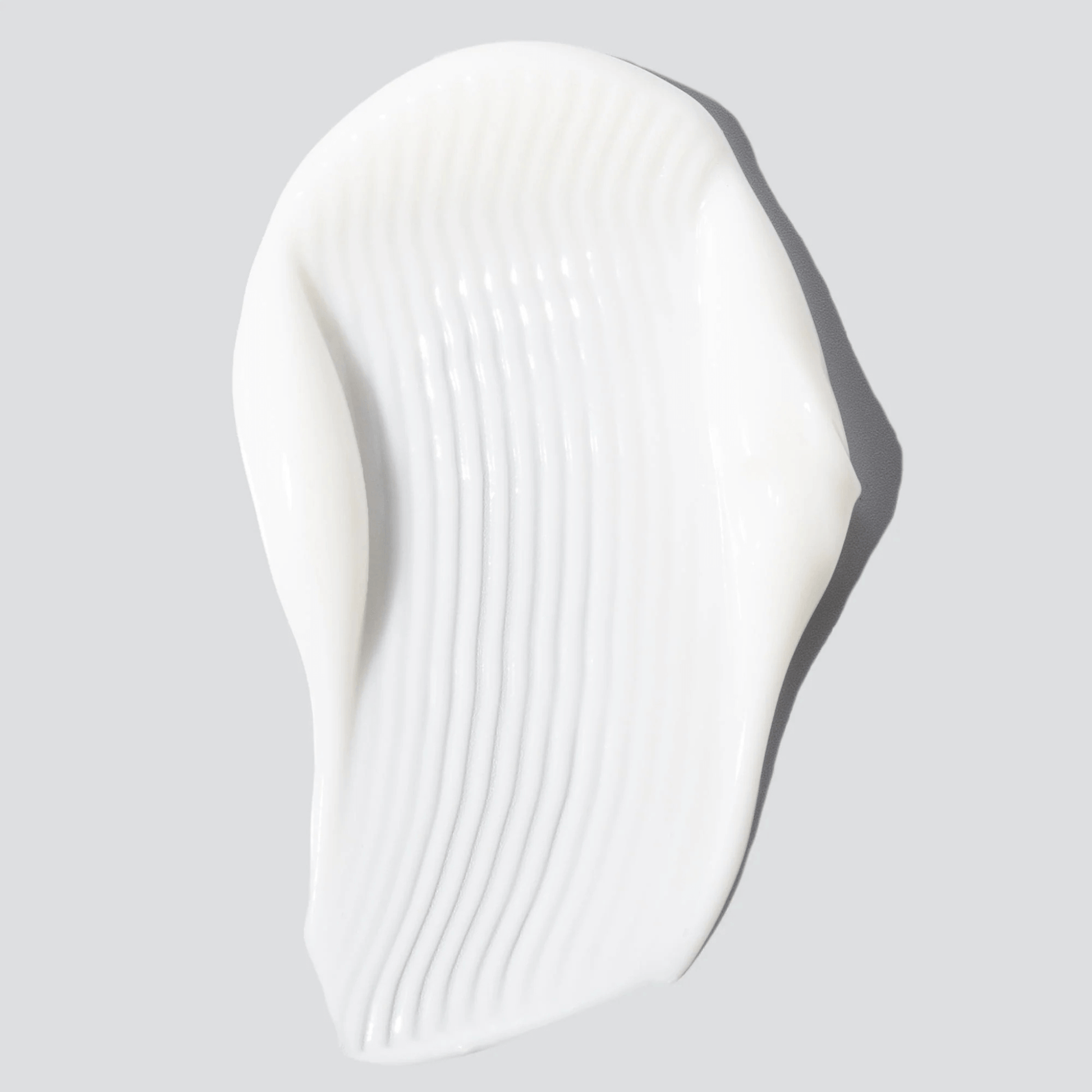 White skincare swatch of Cosmedix Harmonize on a light grey background