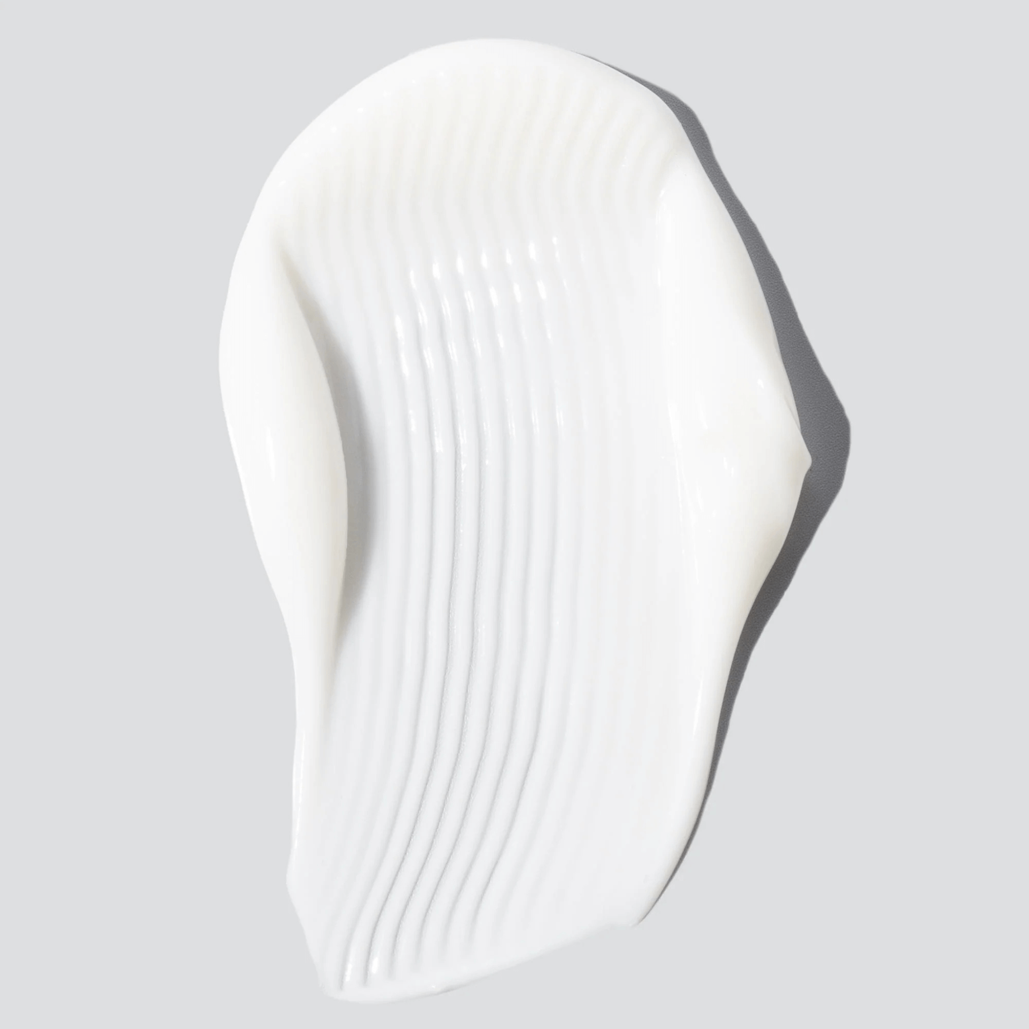 White skincare swatch of Cosmedix Harmonize on a light grey background