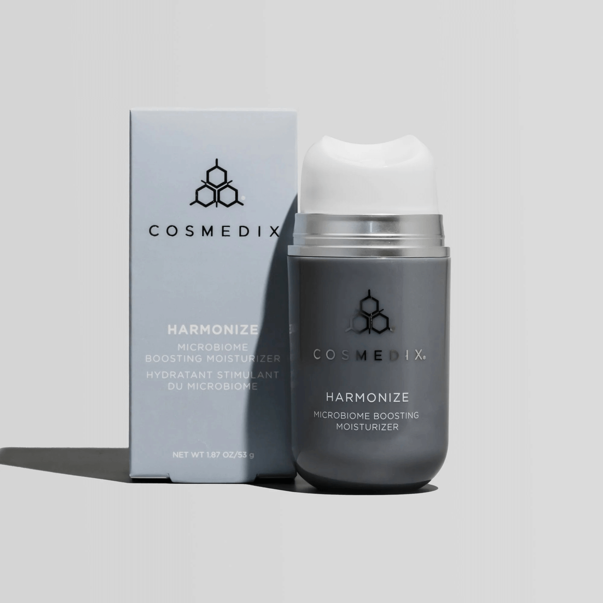 Cosmedix Harmonize moisturiser bottle and packaging on a light grey background